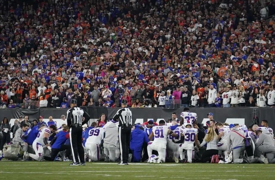 The Buffalo Bills players pray for teammate Damar Hamlin during the first half of an NFL football game against the Cincinnati Bengals, Monday, Jan. 2, 2023, in Cincinnati.