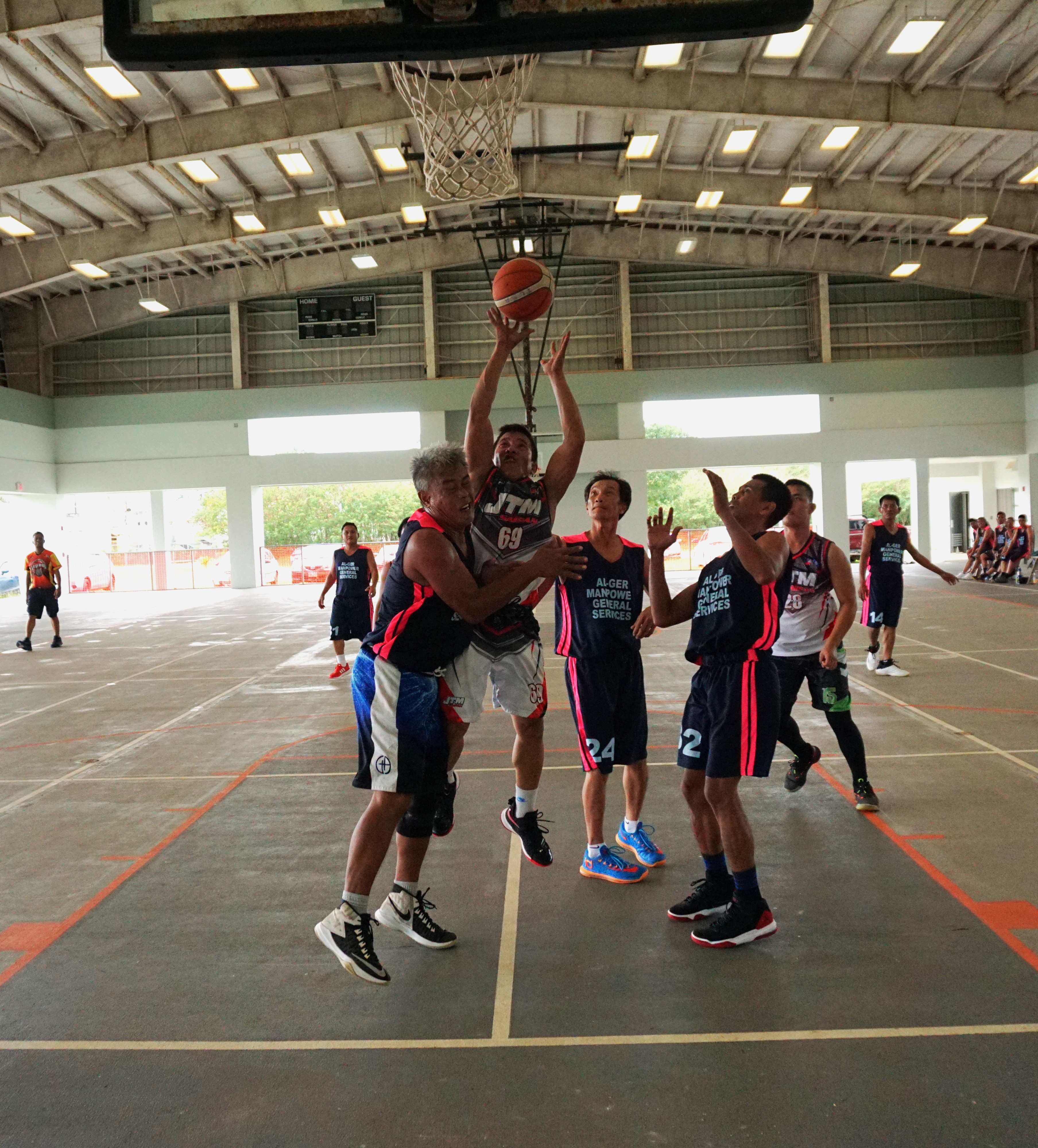 JTM Saipan's Ryan Bayna takes the shot as he gets fouled for the and-one play during an open division game of the Legends Sports Association Invitational Basketball League on Sunday at the Koblerville gym.