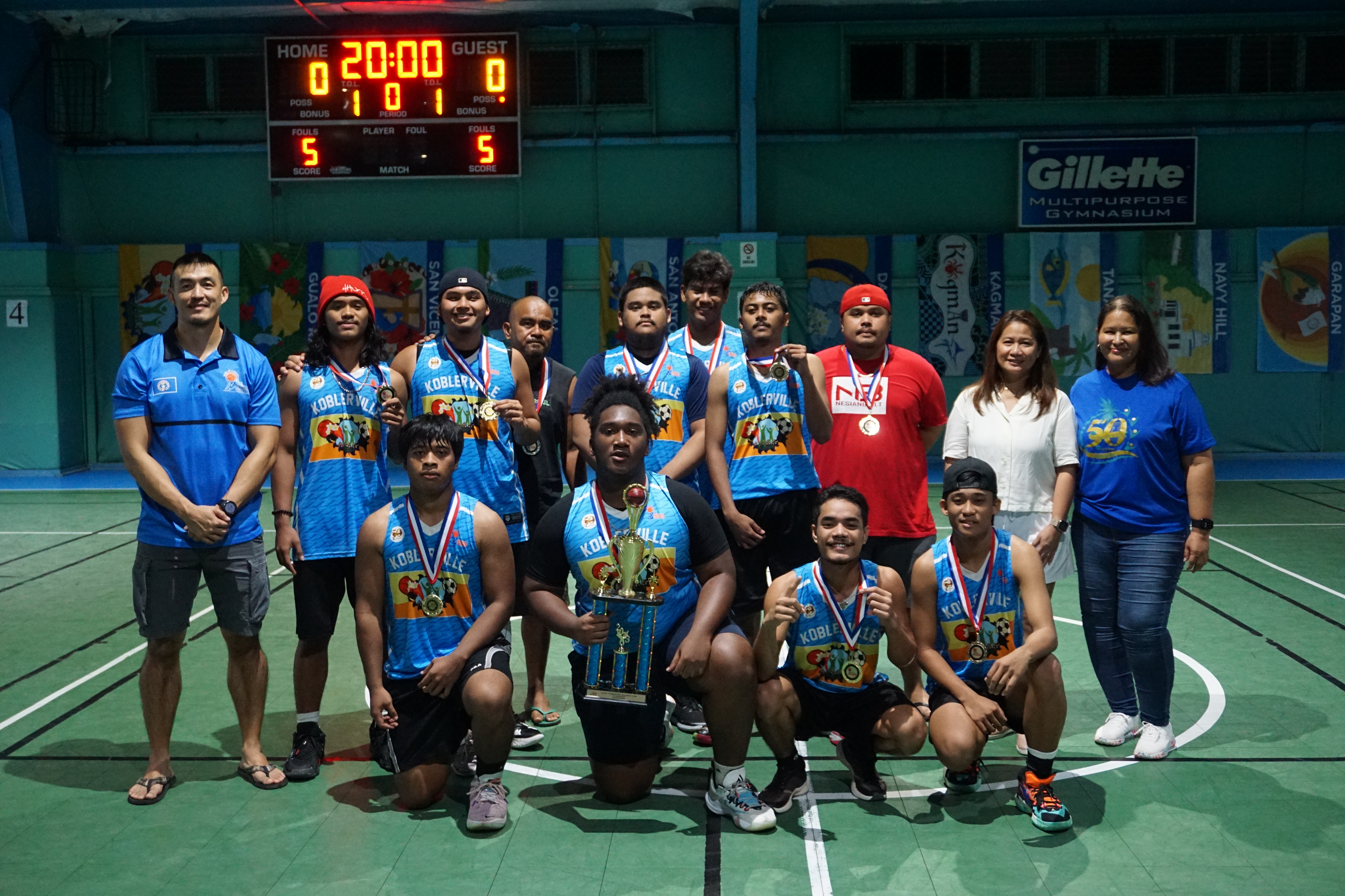 The Koblerville players pose with their medals and the U18 boys division championship trophy during the 2022 Marianas Village Pride Basketball League awards ceremony on Sunday at the TSL Sports Complex.
