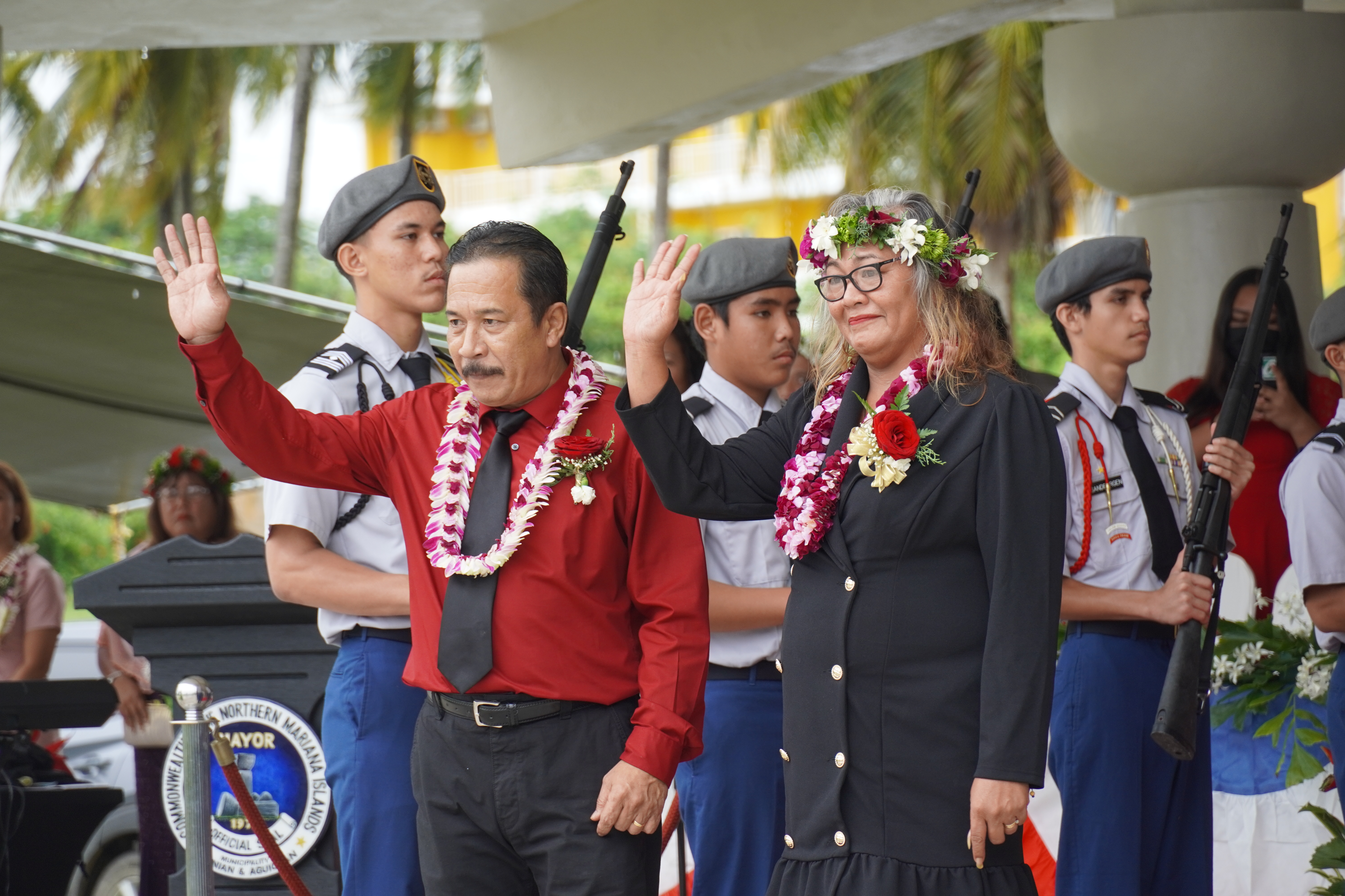 Newly elected Tinian Municipal Council vice chair Ana Marie Cruz San Nicolas, right, and her husband, former Sen. Henry H. San Nicolas, wave at the crowd during the inaugural ceremony Friday on Tinian. 