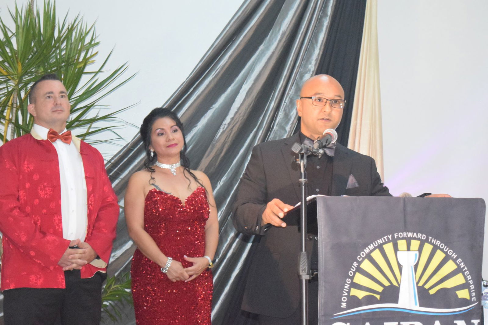 Saipan Chamber of Commerce President Joseph Guerrero delivers his opening remarks as master and mistress of ceremonies Brad Ruzsala and Marcia Calvo look on during the chamber's annual gala at Crowne Plaza Resort Saipan’s Hibiscus Hall on Saturday night.