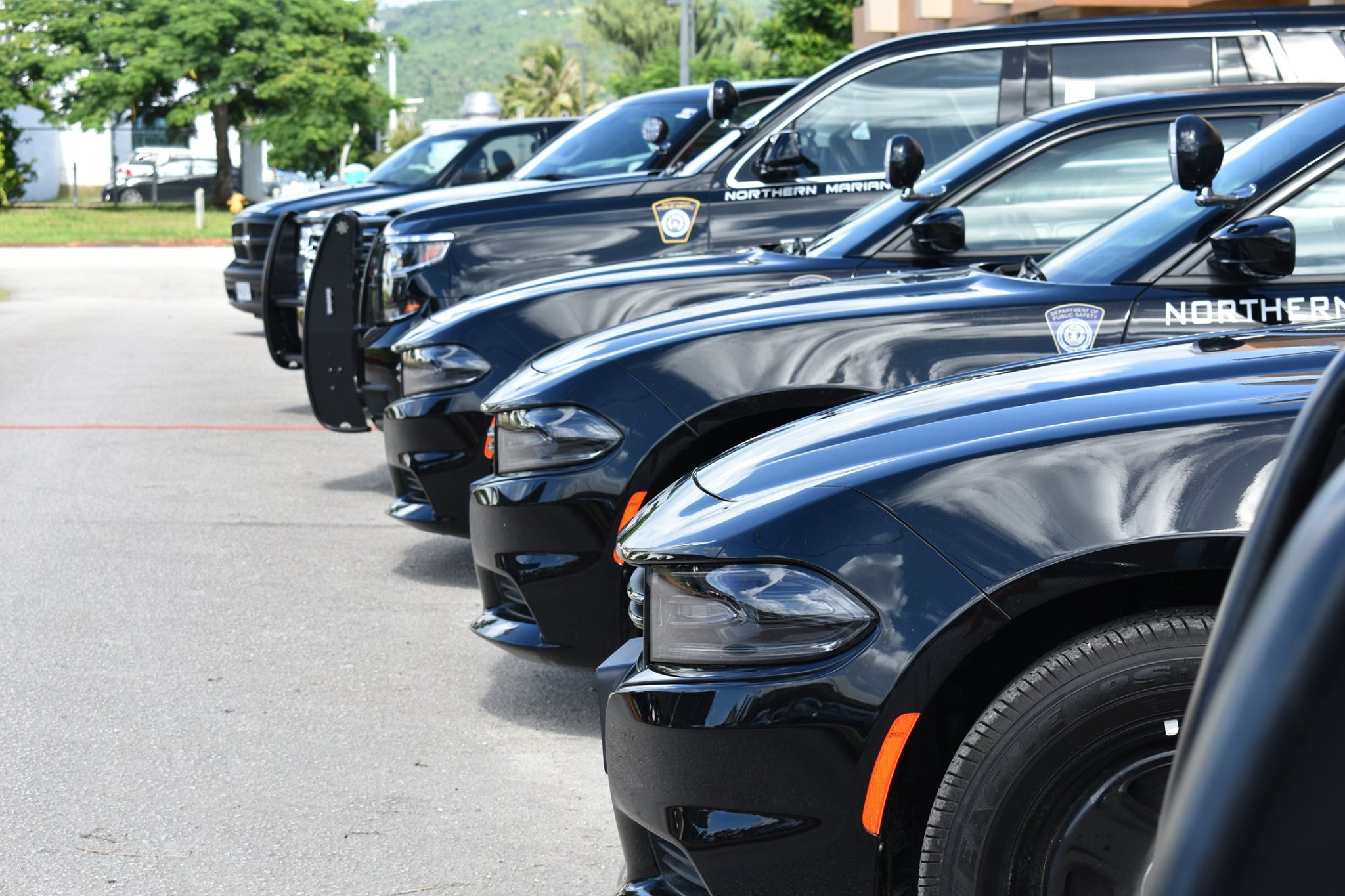 Police vehicles are parked at the Department of Public Safety headquarters in Susupe.