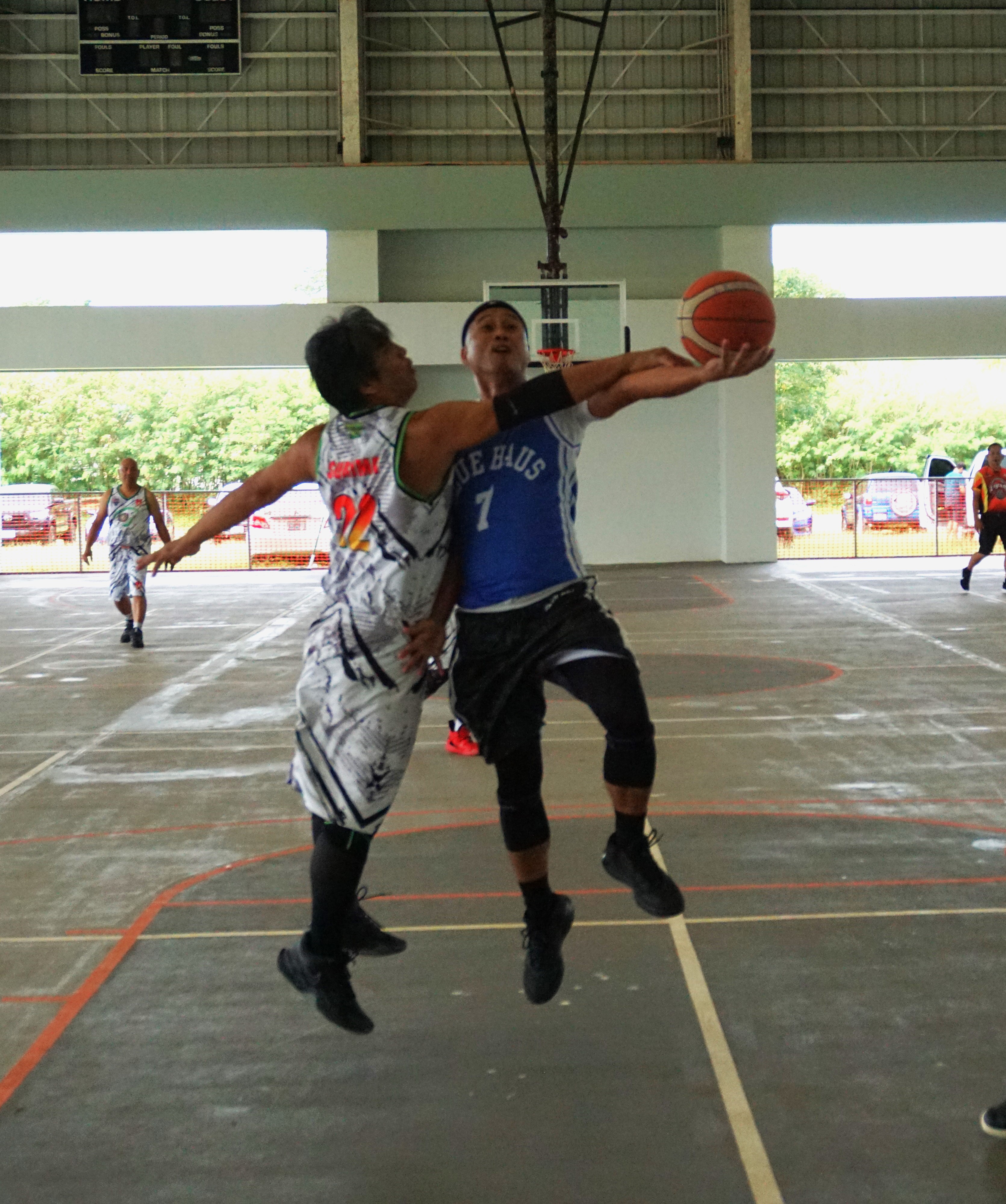 Blue Haus's Elmer Esdrelon gets fouled as he goes up for the layup during a masters division semifinal game of the Legends Sports Association Invitational Basketball League on Sunday at the Koblerville gym.