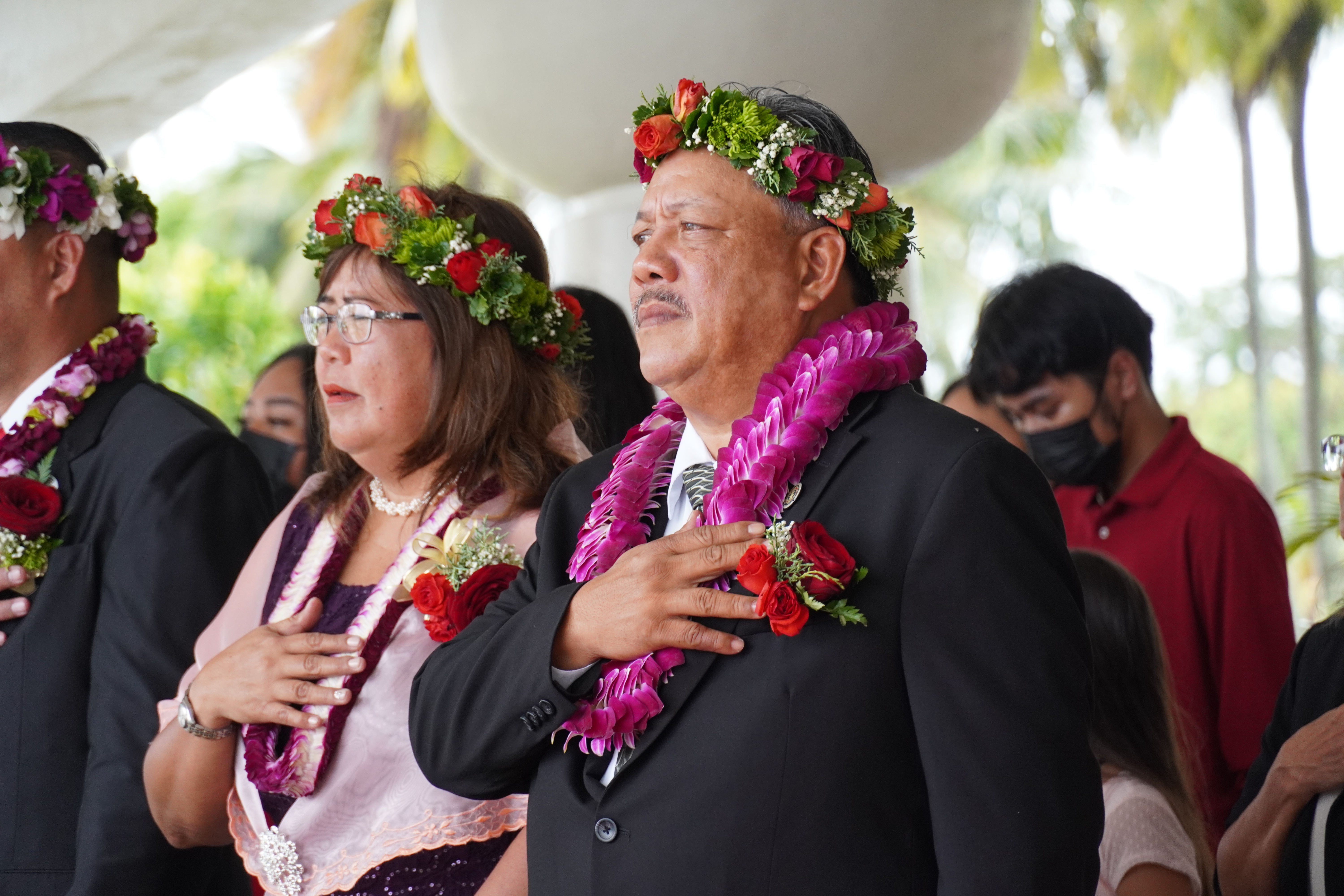 Tinian and Aguiguan Mayor Edwin P. Aldan and his wife Rosita place their right hands over their hearts as they sing the CNMI anthem.