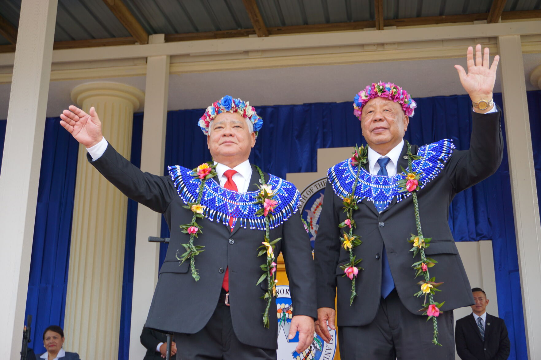 Newly sworn in Gov. Arnold I. Palacios, left, and Lt. Gov. David M. Apatang, right, wave at dignitaries and community members.