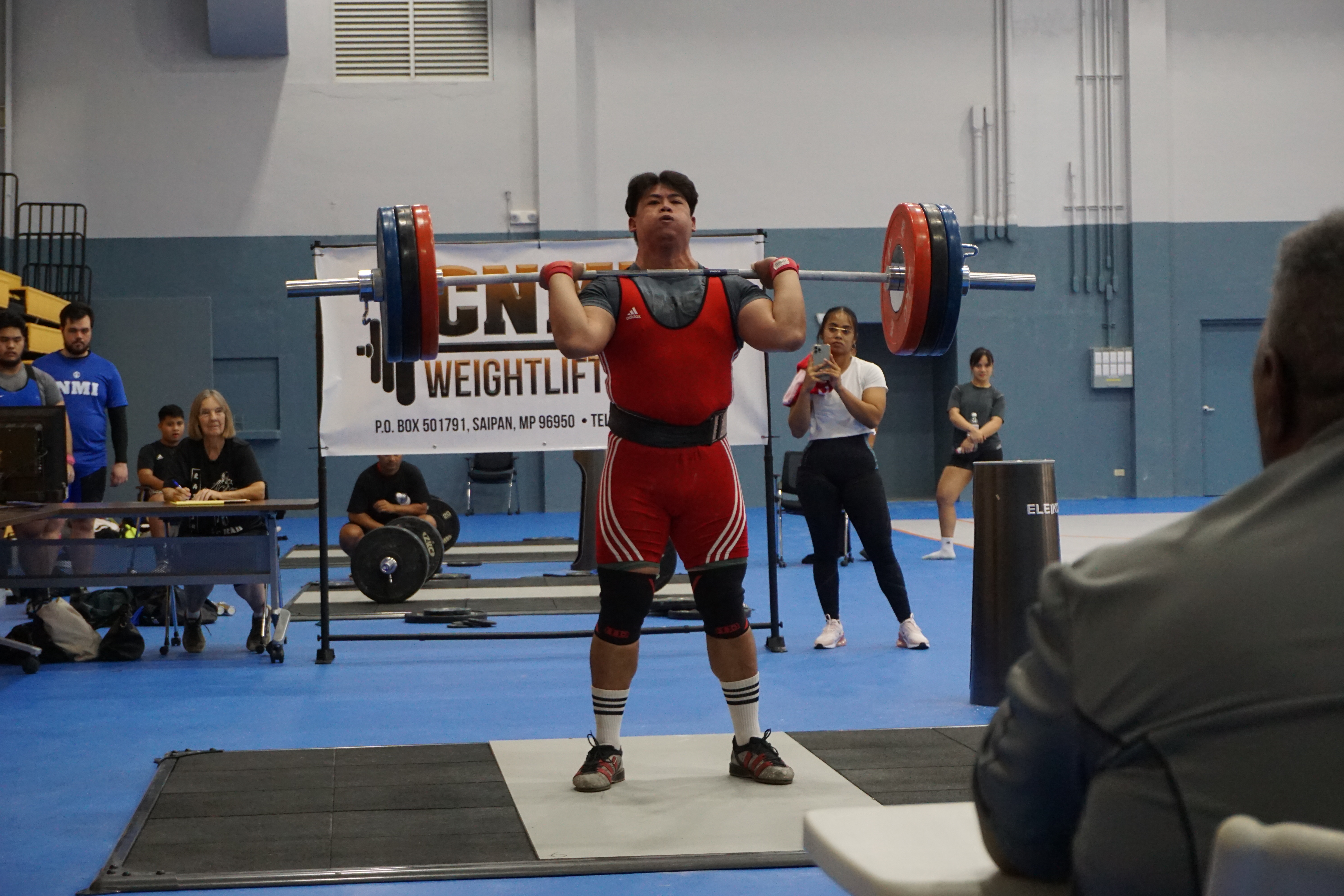 Angel San Nicolas preps to complete his 165kg clean & jerk lift during the CNMI Weightlifting qualifier at the Ada gym on Saturday.