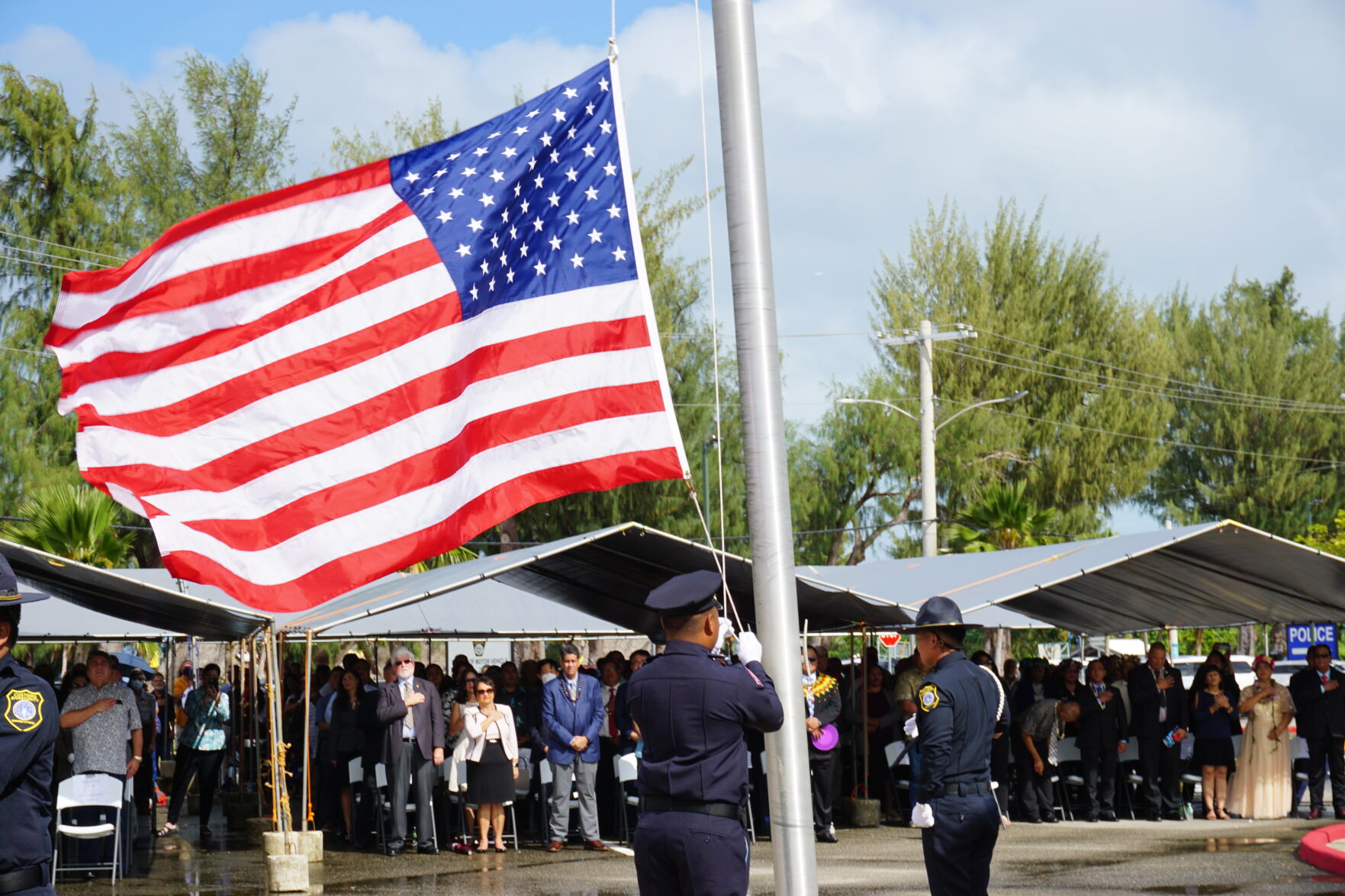 Two members of the CNMI Color Guard raise the U.S. flag.