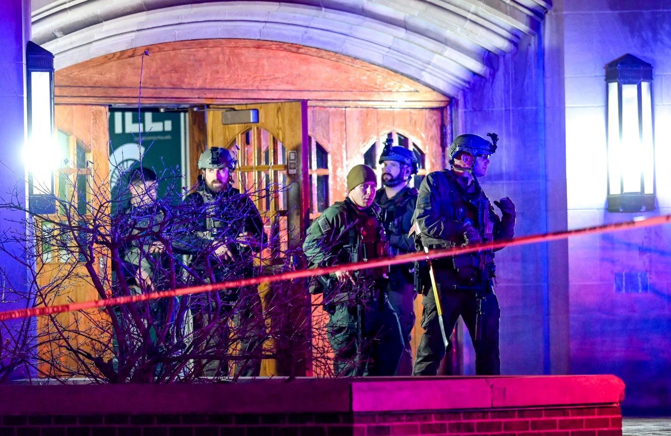 Police walk around Berkey Hall after a shooting on the Michigan State campus in East Lansing, Michigan, Feb. 14, 2023.