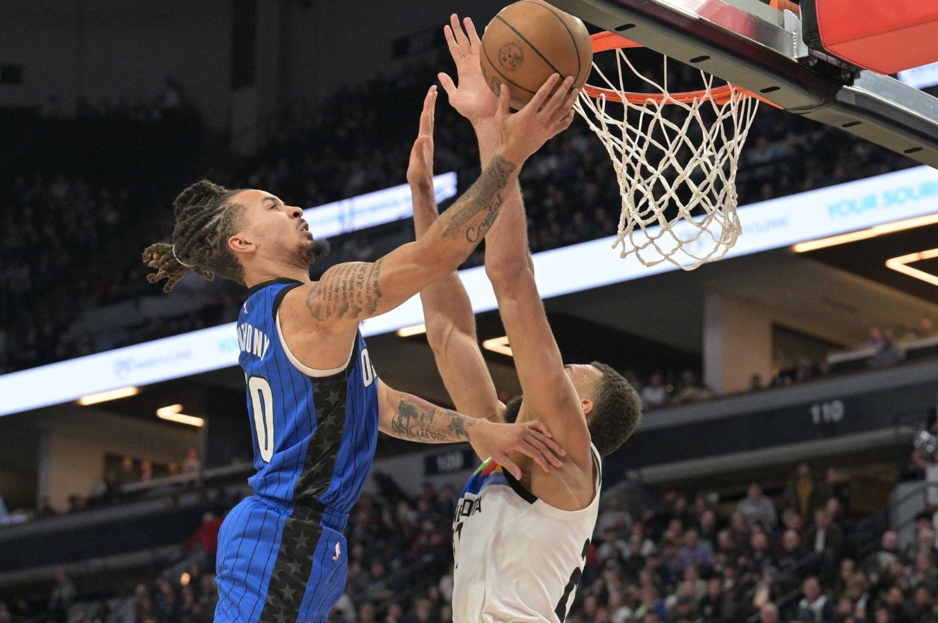 Orlando Magic guard Cole Anthony (50) goes to the basket as Minnesota Timberwolves center Rudy Gobert (27) defends during the second quarter at Target Center in Minneapolis, Minnesota, Feb. 3, 2023.