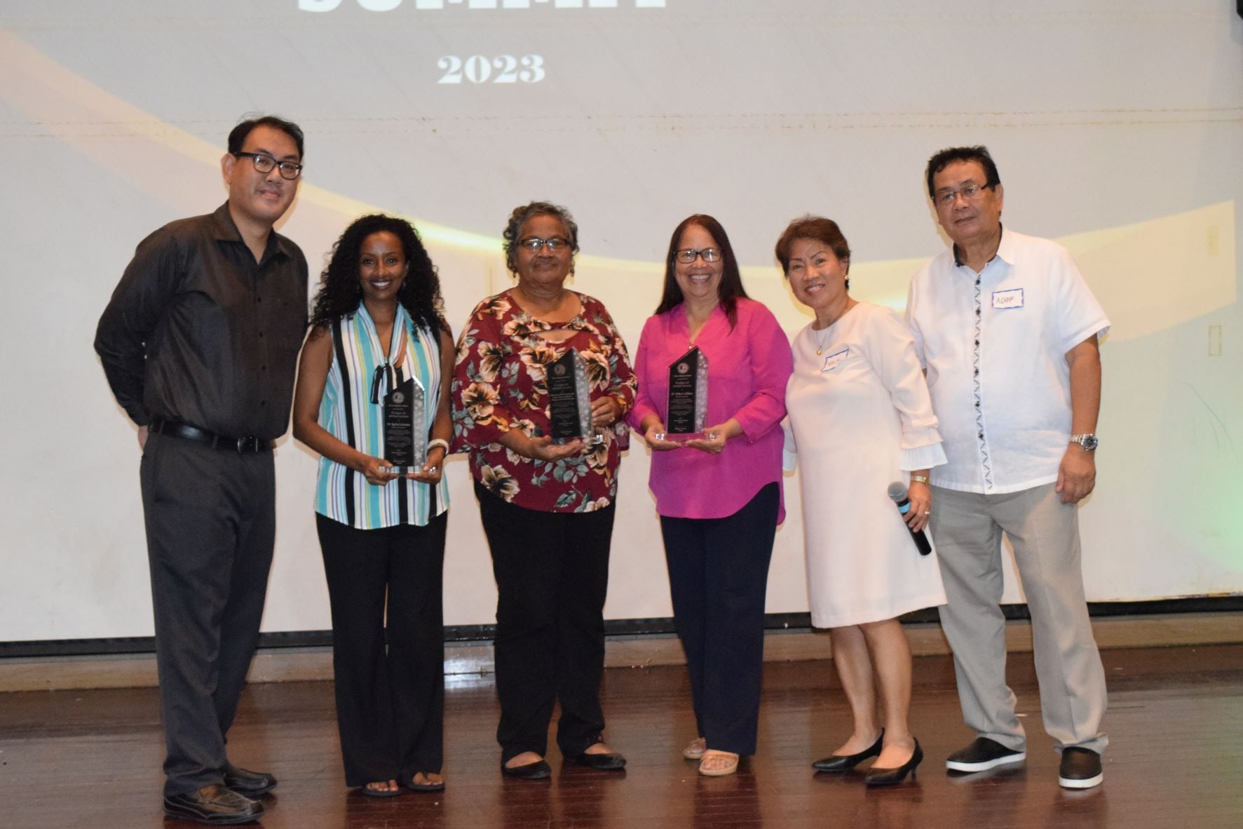 From left, Green Meadow School President Glenn Songcuan, Northern Marianas College Associate Professor Dr. Beylul Solomon, Division of Youth Services Family and Youth Enhancement Program Coordinator Maria Olopai, former Education Commissioner Dr. Rita A. Sablan, GMS Principal Milagros Songcuan and GMS Chairman of the Board Saturnino Songcuan pose for a photo during the GMS Parents Summit at the Saipan World Resort's Royal Taga Hall on Monday.