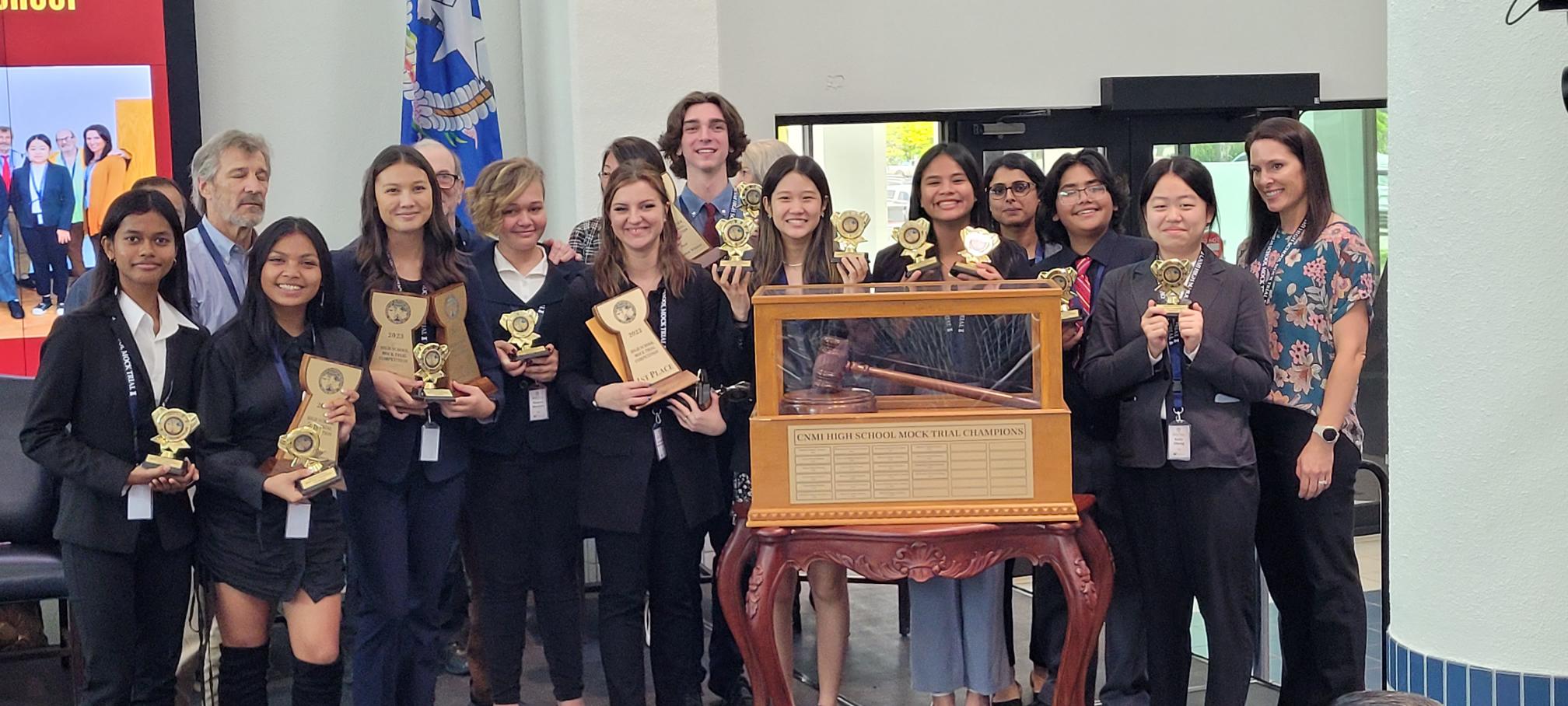 The Marianas High School mock trial team members pose for a photo with their teachers and attorney coaches after winning the perpetual gavel trophy at Guma Hustisia on Friday.