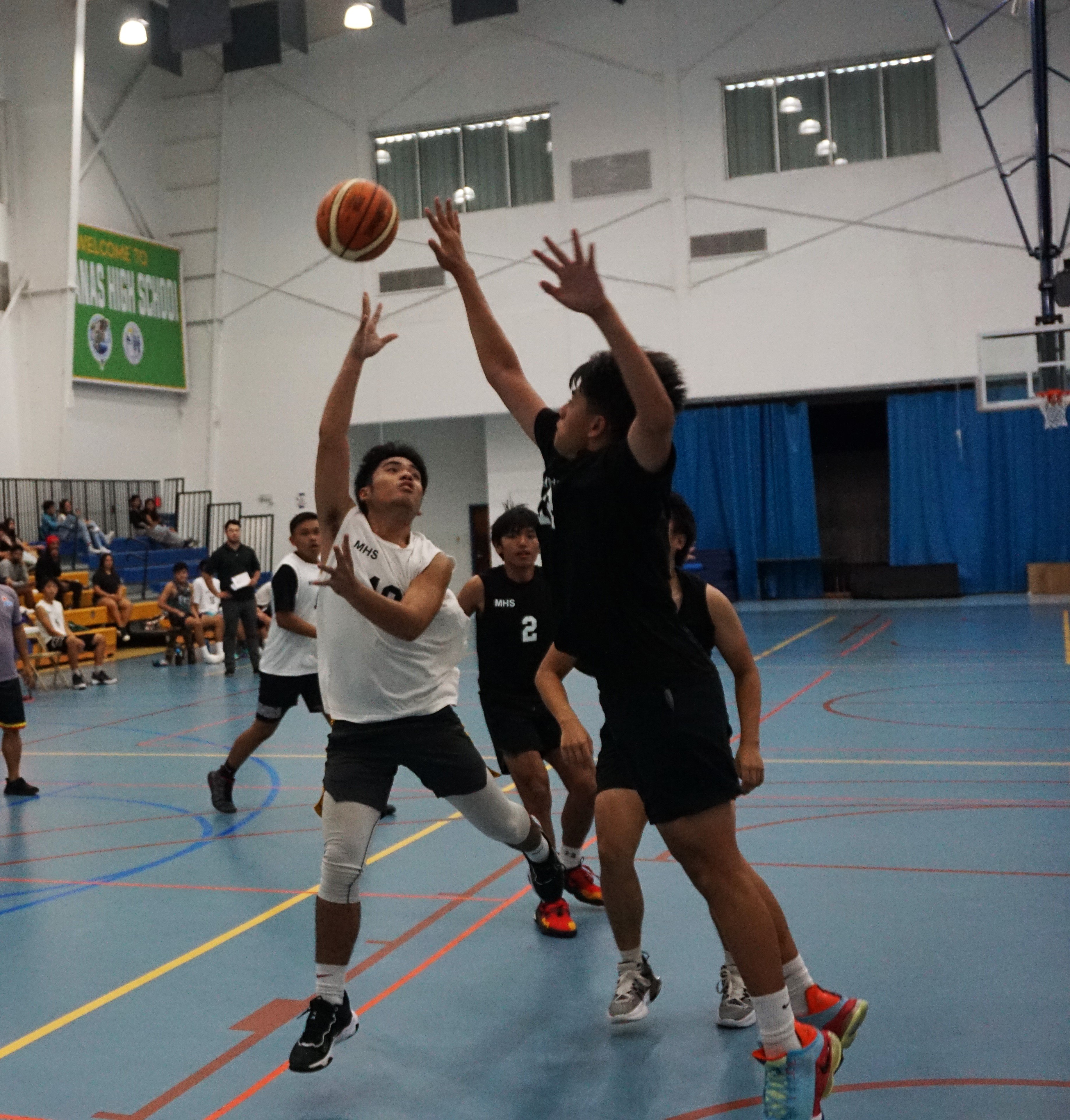MHS JV1 's Juan Escalada takes the off-balanced shot during a high school division game of the IT&E Interscholastic Basketball League on Wednesday at the MHS gym