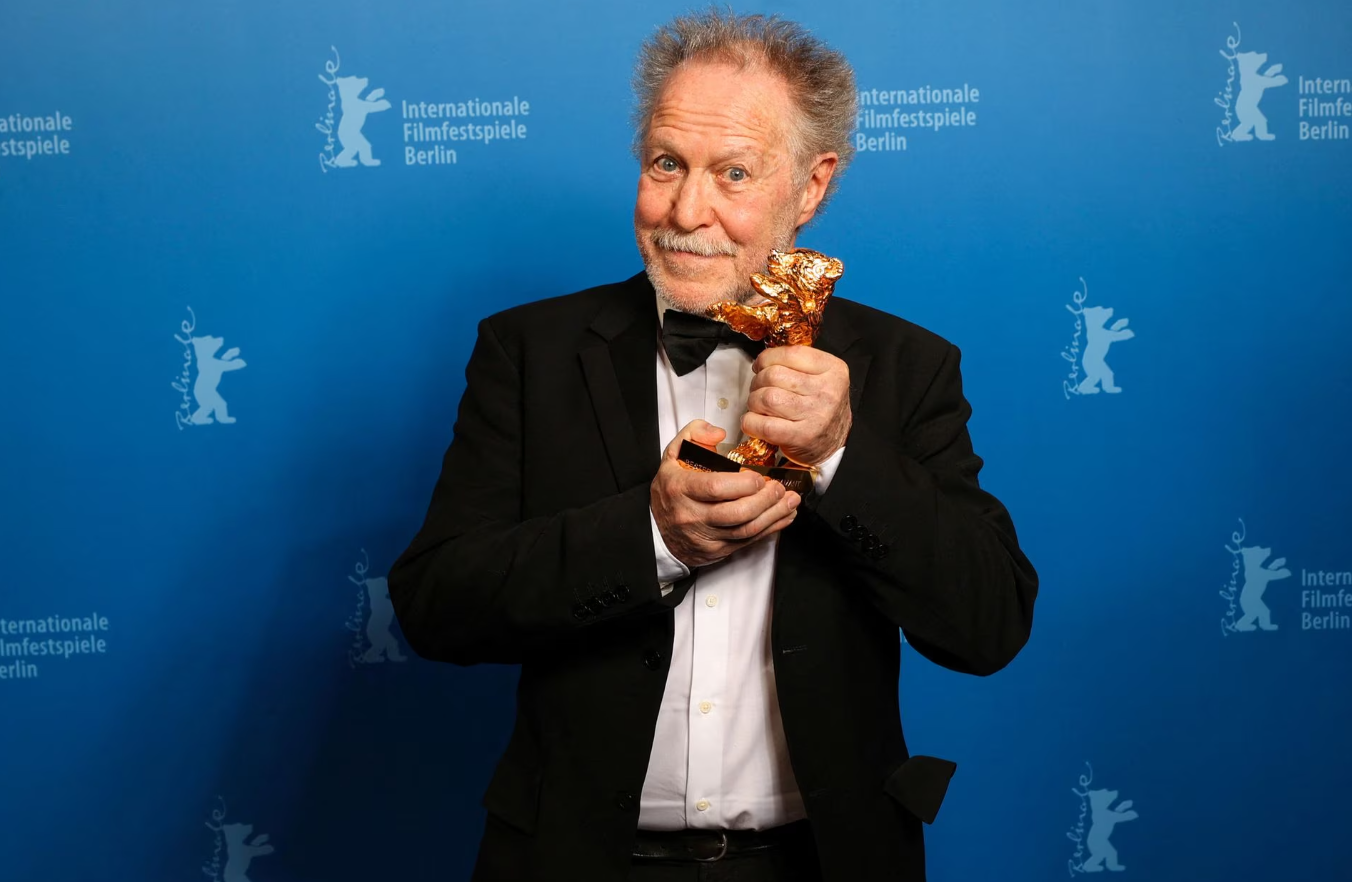 Nicolas Philibert poses for a photo with the Golden Bear for Best Film for "On the Adamant" at the 73rd Berlinale International Film Festival in Berlin, Germany, Feb. 25, 2023.
