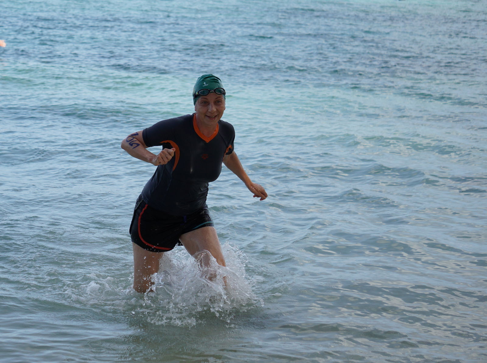 Yulia Aleksenko smiles as she rushes to the finish line in the 1500m race of the Tan Holdings 50th Anniversary Ocean Swim on Saturday.