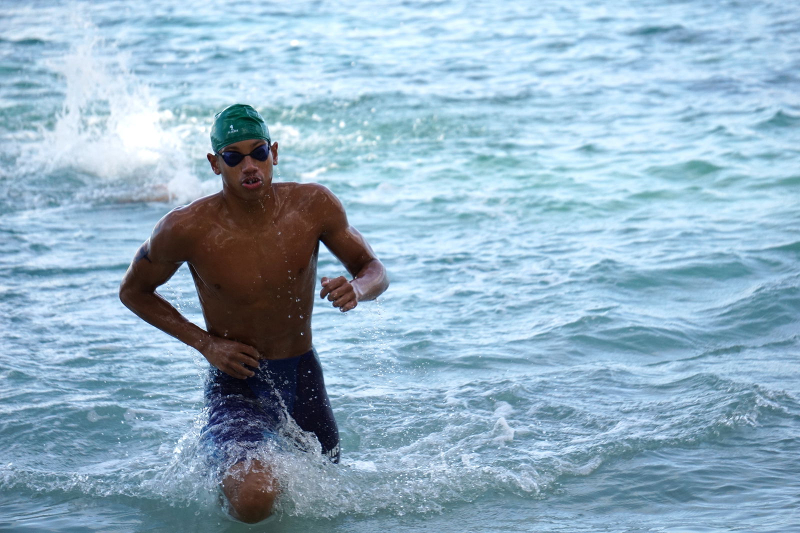 Isaiah Aleksenko rushes to the finish line in the male 1500m race of the Tan Holdings 50th Anniversary Ocean Swim on Saturday at Guma Sakman.