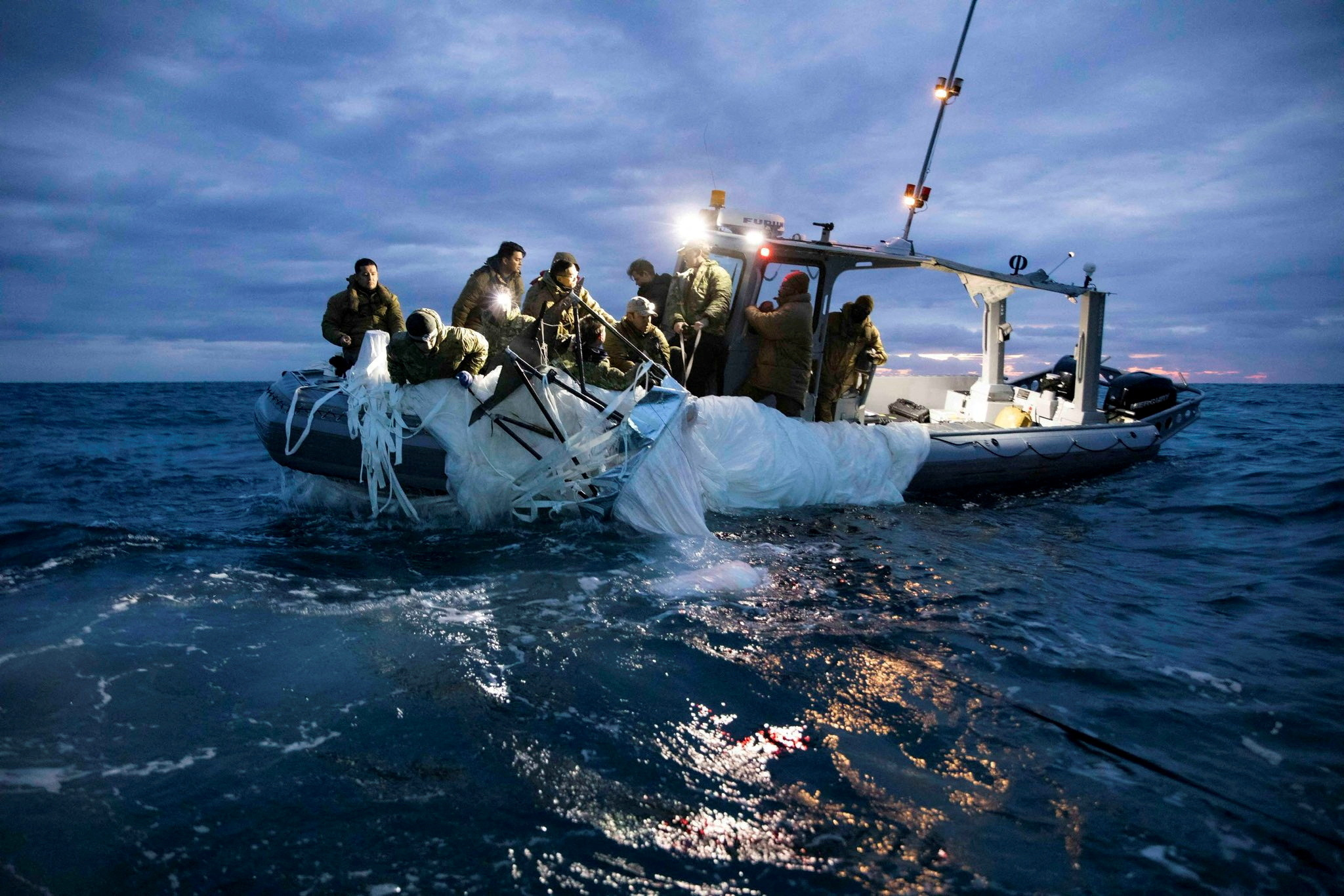 Sailors assigned to Explosive Ordnance Disposal Group 2 recover a suspected Chinese high-altitude surveillance balloon that was downed by the United States over the weekend over U.S. territorial waters off the coast of Myrtle Beach, South Carolina, Feb. 5, 2023.