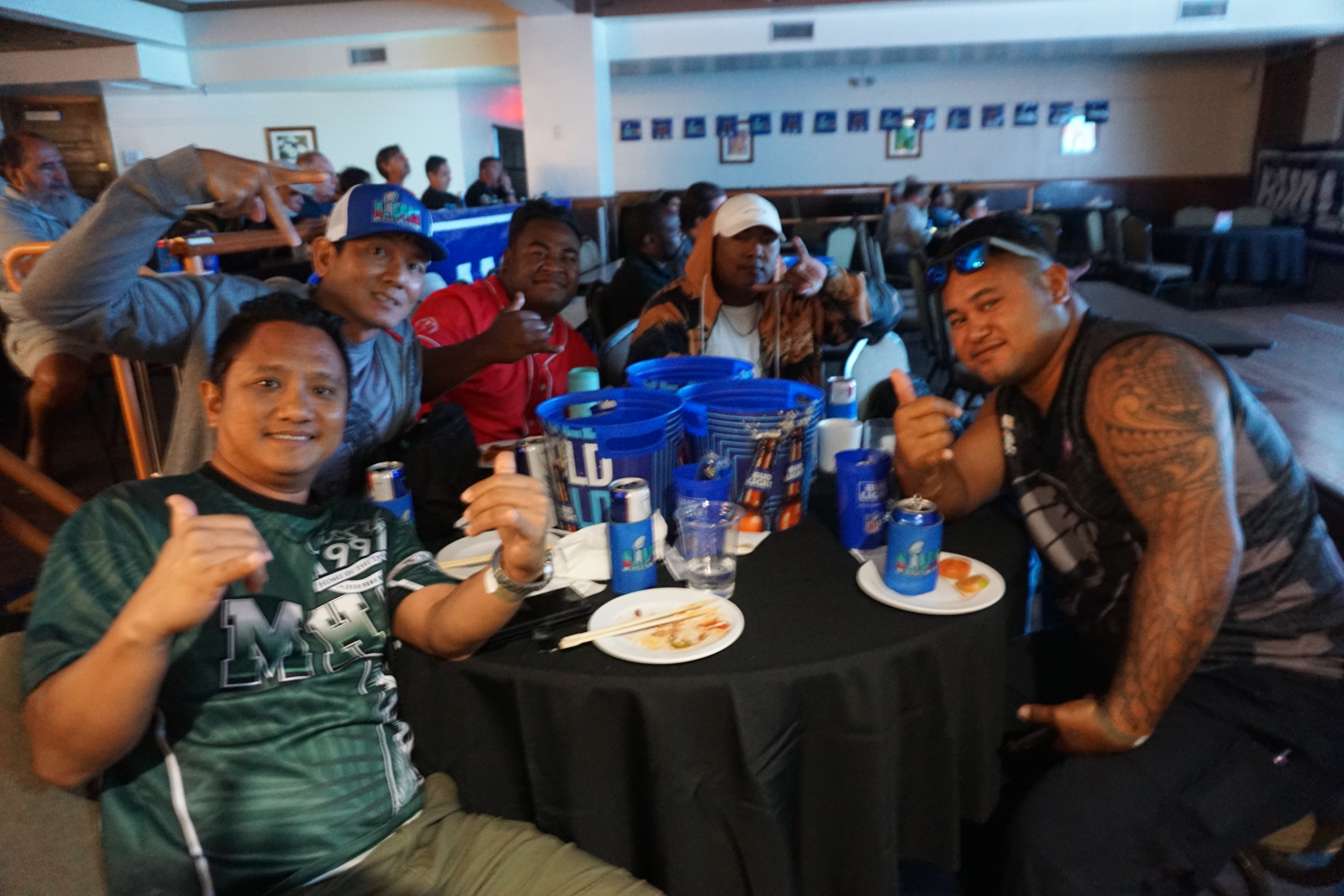 Chiefs and Eagles fans sit together as they watch Super Bowl LVII at Charley's Cabaret of the Pacific Islands Club Saipan. 