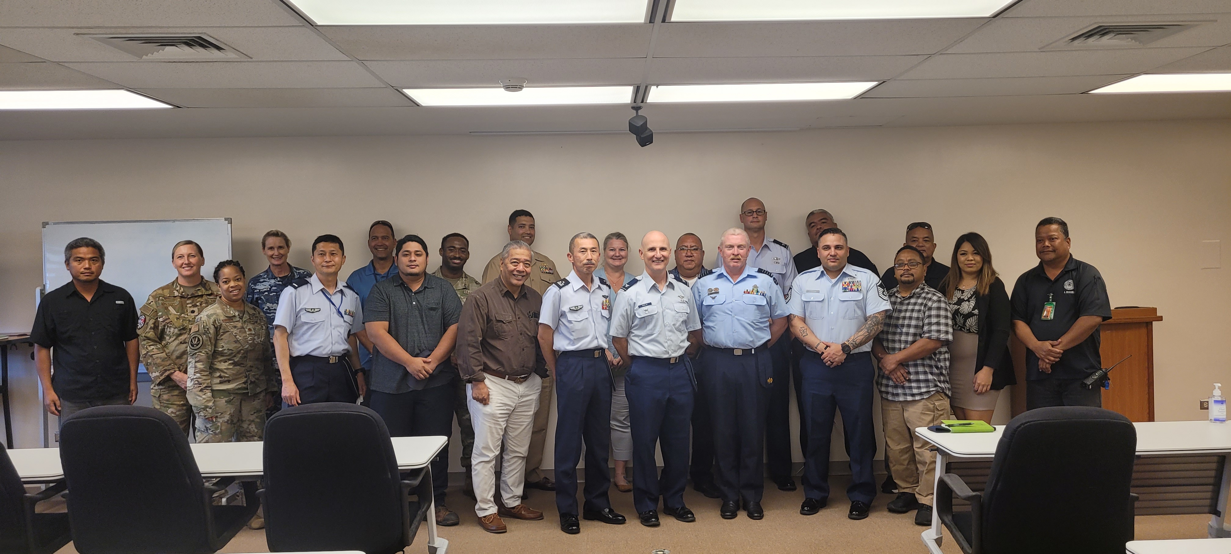 Daniel Aquino, special assistant for the Bureau of Military Affairs, poses for a photo with Japan Self-Defense Force 9th Wing Flight Commander Col. Inadome Satoru, U.S. Air Force Col. Jared Pasley, Royal Australian Air Force Capt. Robert Graham and other military and local officials during the Cope North 2023 public hearing at the Francisco C. Ada/Saipan International Airport on Tuesday.