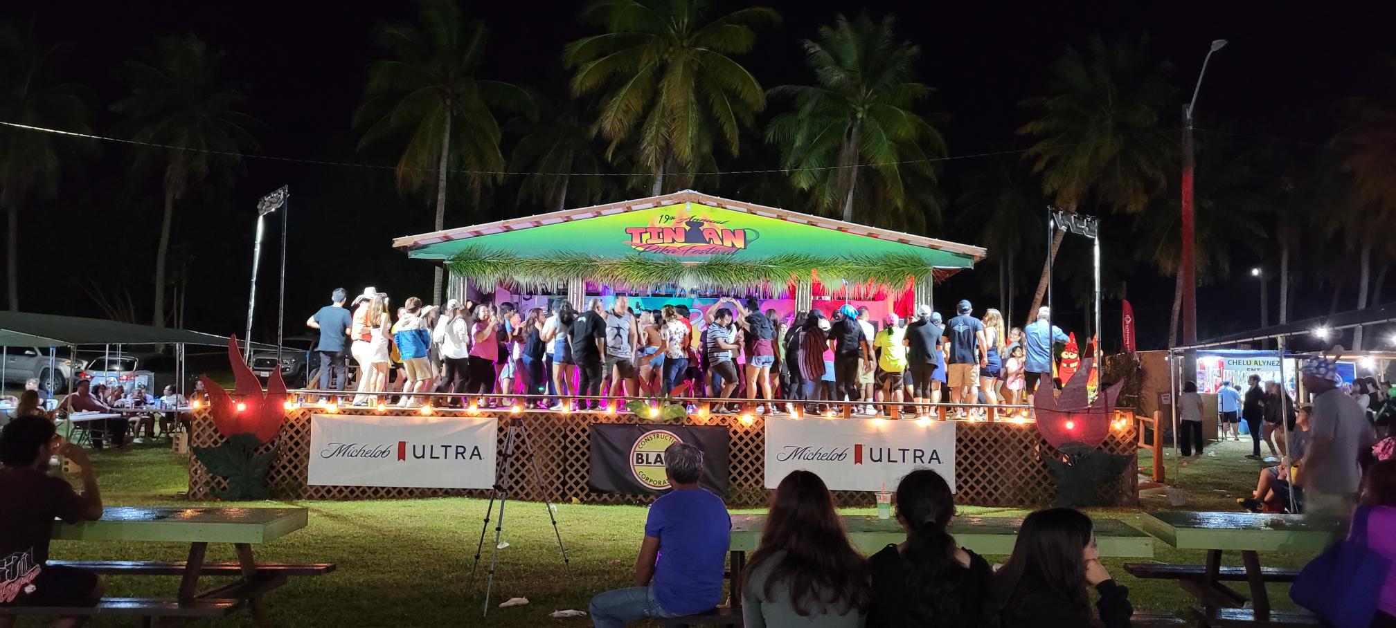 Tinian residents and visitors dance on stage during Pika Fest on Saturday evening