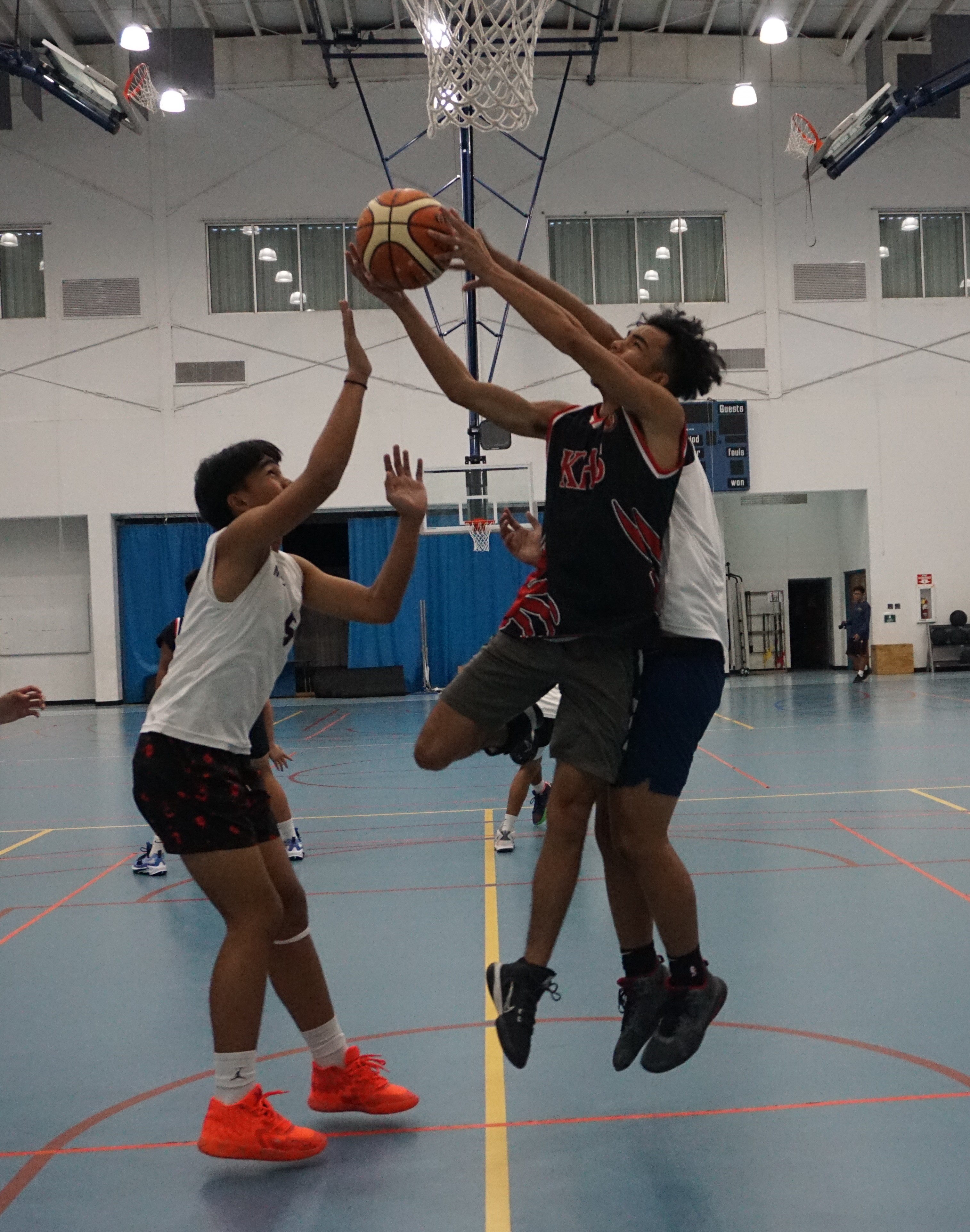 KHS JV's Darien Quitugua gets fouled as he goes up for the shot during a boys high school division game of the IT&E Interscholastic Basketball League at the MHS gym on Friday.
