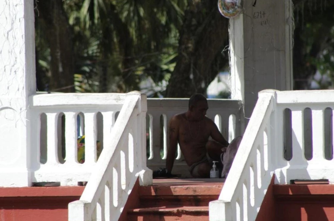 A homeless man sits under a concrete pavilion in Hagåtña on Jan. 23, 2023. Attorney General Douglas Moylan touched on a number of topics, including problems mayors encounter with homeless people, during a council meeting Wednesday, Feb. 15, 2023.