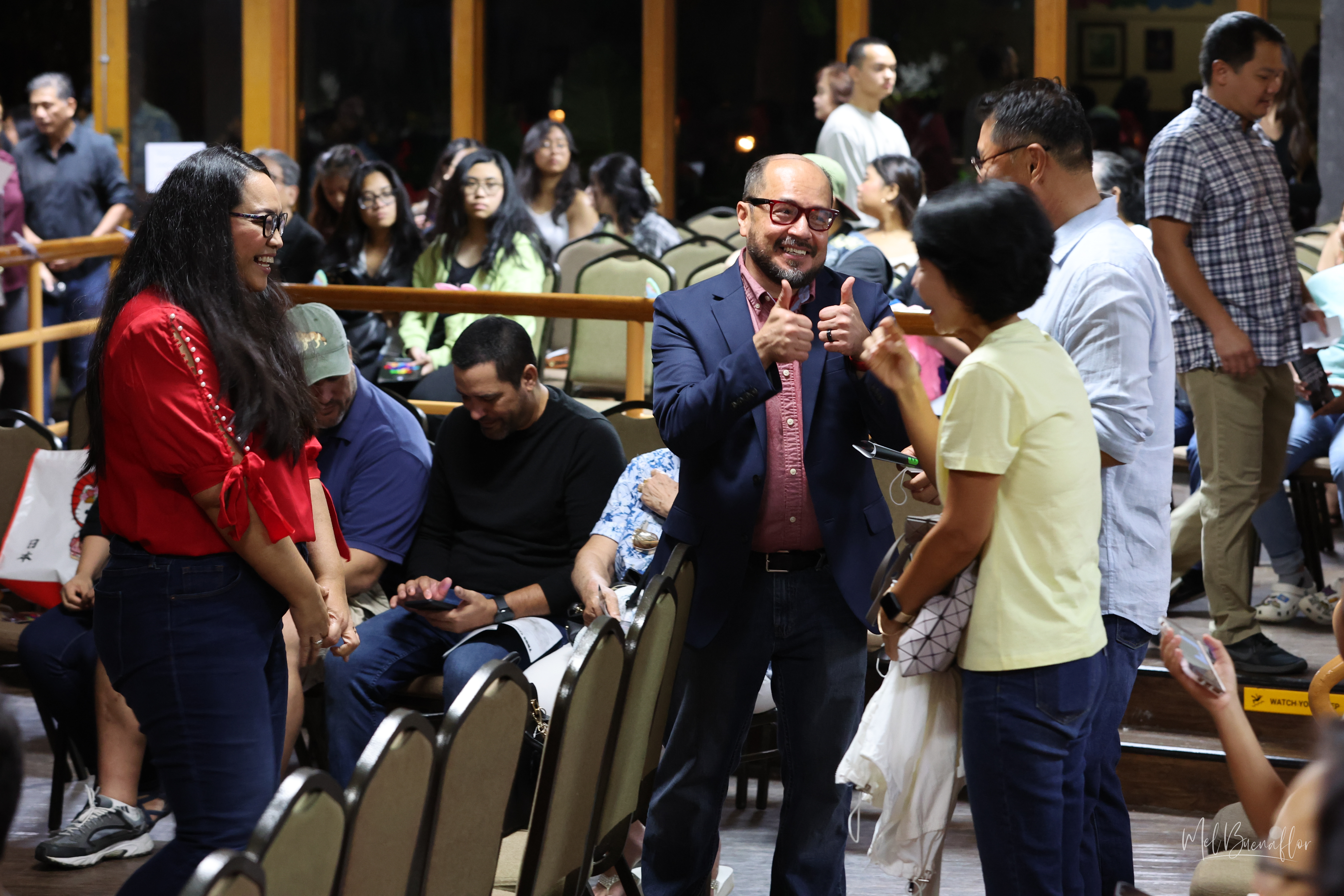 During intermission before a full house, Theatre Club adviser and show writer and producer, Galvin Deleon Guerrero, EdD, center, congratulates the parents of Eunkyu "Joey" Hong, who played Luke, giving their son “two thumbs up” for his performance, as Deleon Guerrero’s wife, Velma, left, looks on.