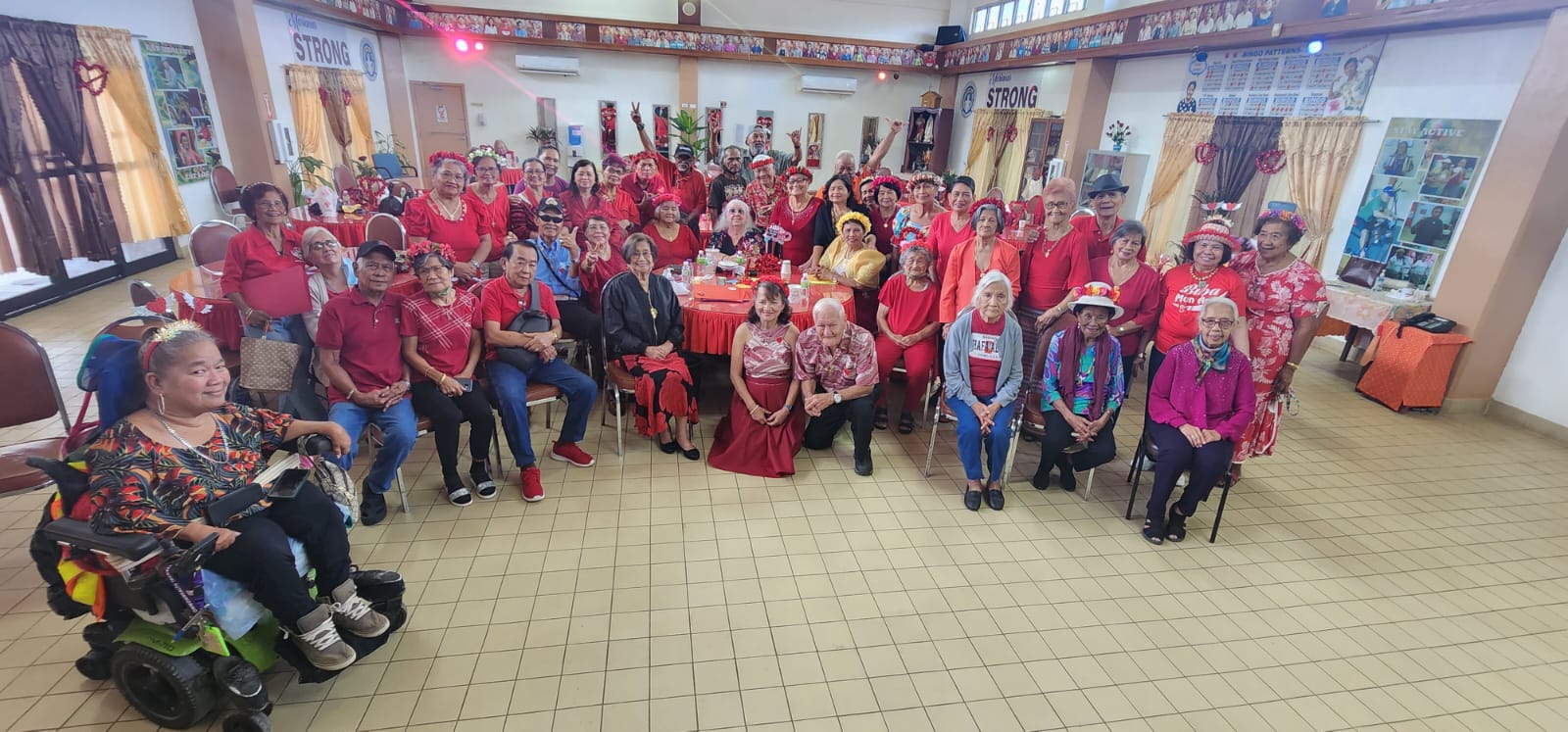 Senior citizens pose for a photo during the Valentine’s Day celebration at the manamko’ center on Tuesday, Feb. 14, 2023.