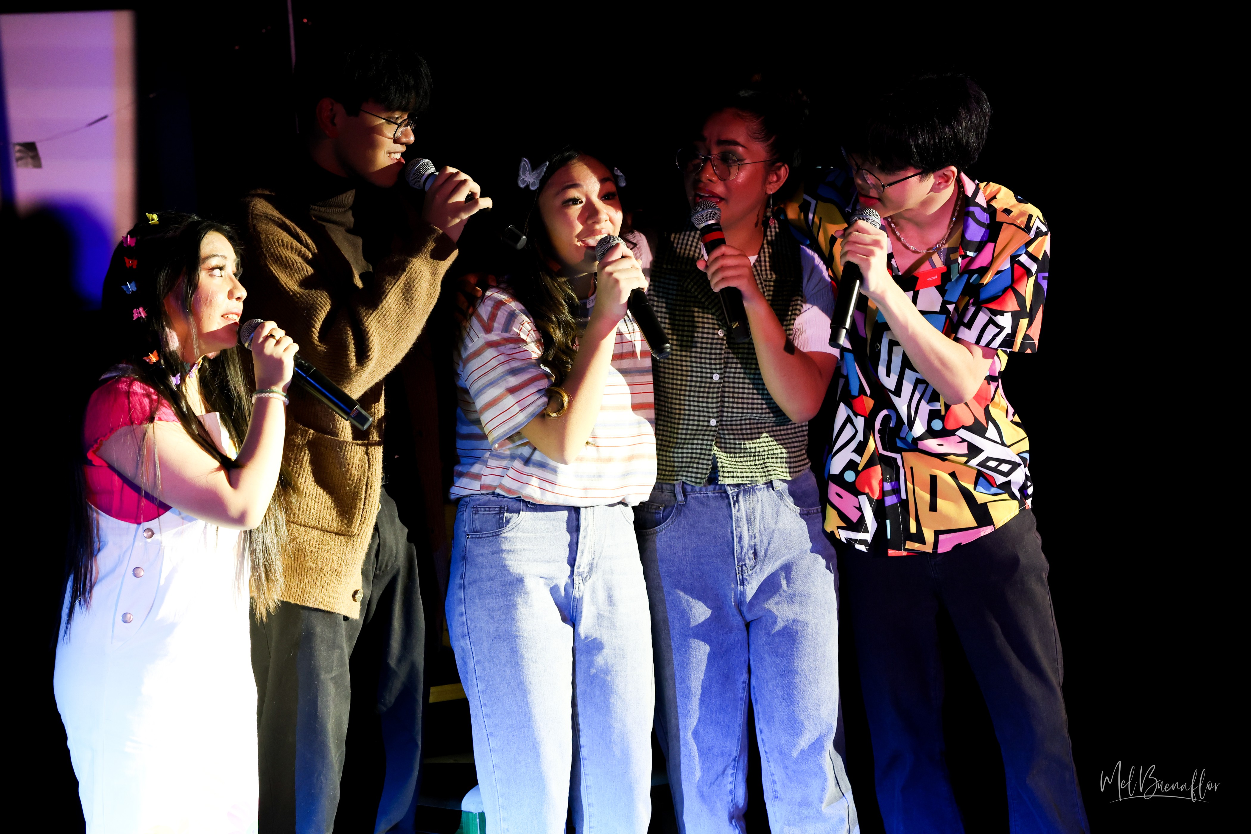 Bernice Shane Sabino, center, finds her place in the school’s Theatre Club, led by Ally, played by Kinamarie M. Dela Cruz, second from right, and filled with colorful characters like Kyle, played by Brent Matthew Estacio Ortizo, far right, Kim, played by Jill Anne Mallari, far left, and Kin, played by Manuel Jacinto M. Pangelinan. Here, they comfort Iris by singing “It’s OK” together.