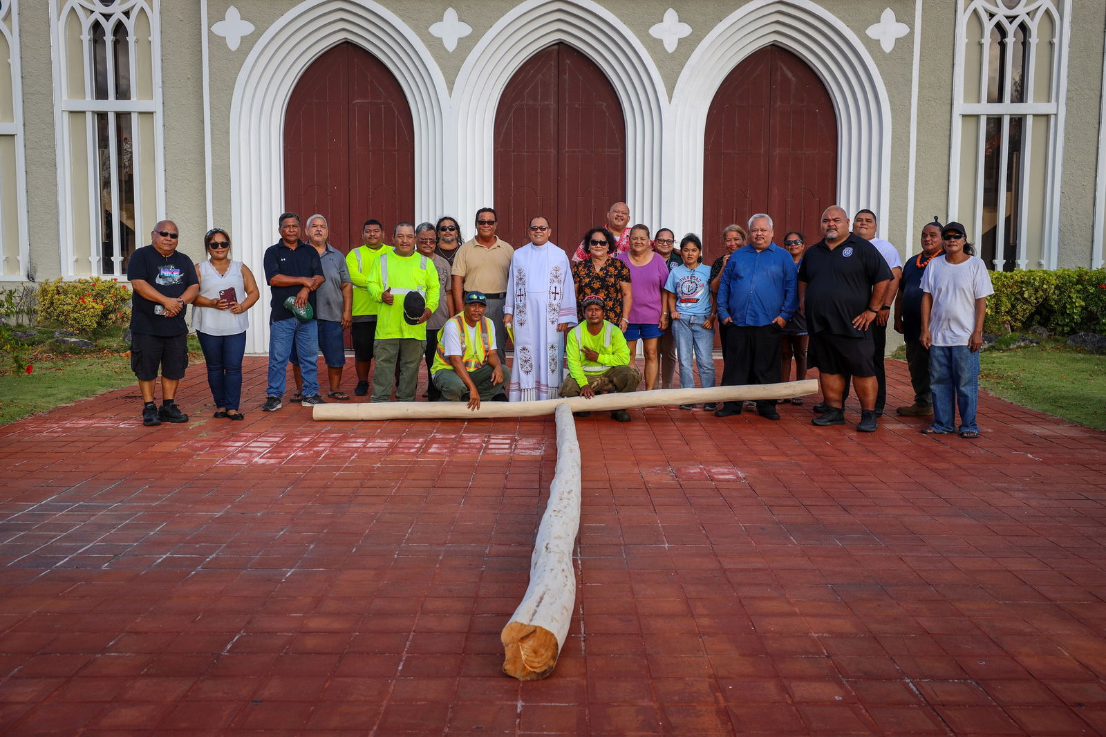 Rev. Fr. Rey D. Rosal, center, and family members of the late Francisco "Tun Ko" Palacios pose for a photo with Saipan Mayor Ramon B. Camacho during the public veneration of the Lenten cross at Mt. Carmel Cathedral on Tuesday.