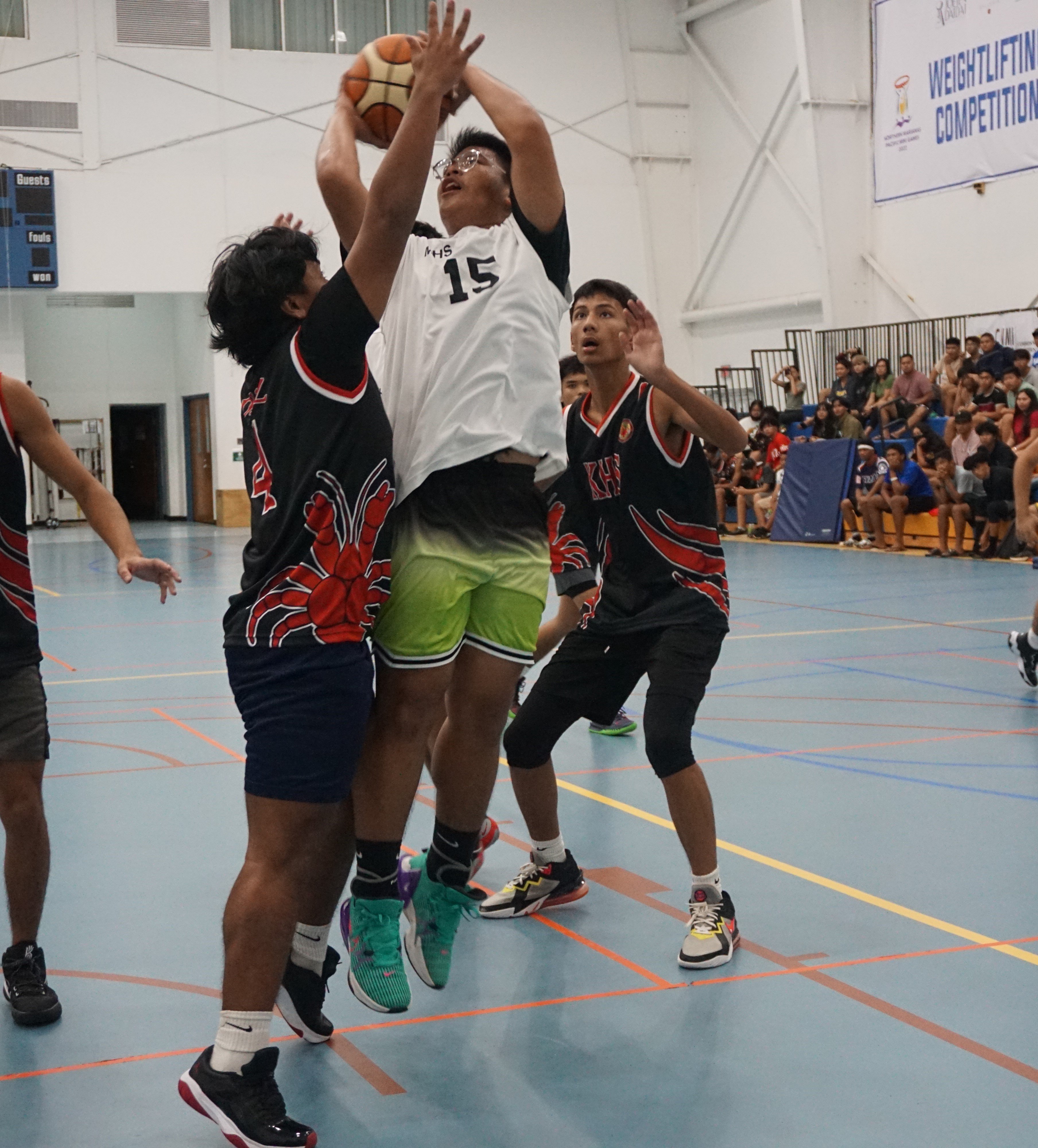 MHS JV's Marl Balignasay attempts to take the shot as he is smothered by SSHS JV defenders during a boys high school division game of the IT&E Interscholastic Basketball League at the MHS gym on Friday.