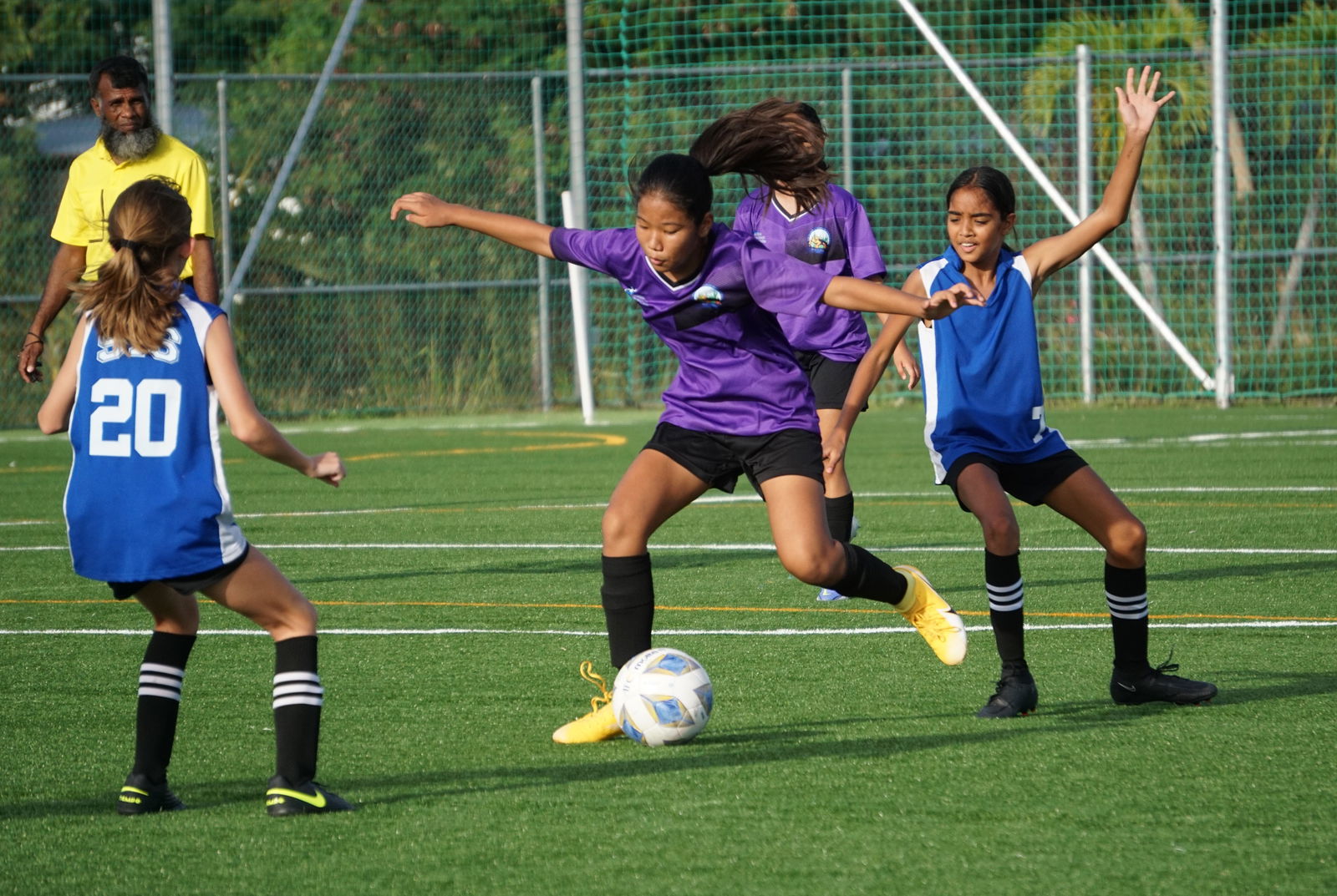 HMS' Yelynn Ha slips between defenders during a girls middle school division game of the NMIFA-PSS Interscholastic Soccer League on Thursday last week at the NMI Soccer Training Center.