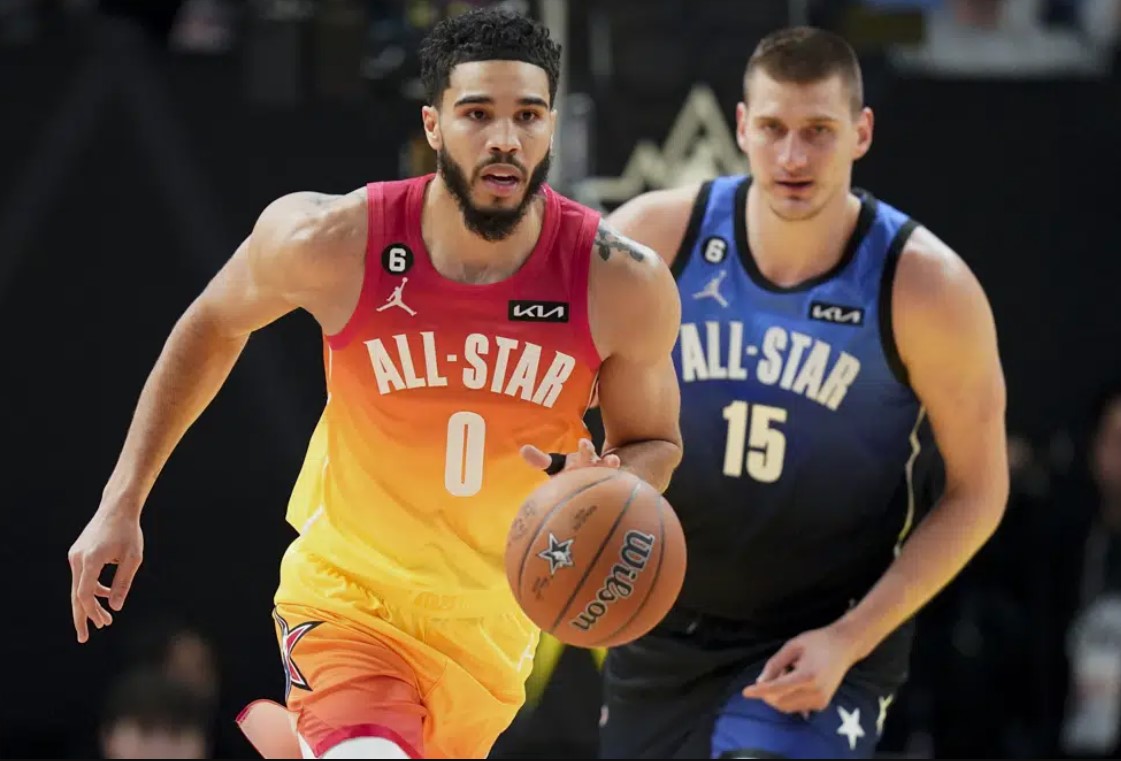 Team Giannis forward Jayson Tatum (0) drives past Team LeBron center Nikola Jokic (15) during the first half of the NBA basketball All-Star game Sunday, Feb. 19, 2023, in Salt Lake City.
