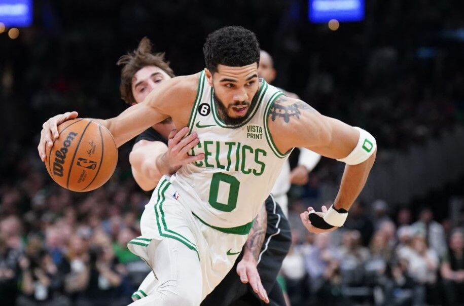 Boston Celtics forward Jayson Tatum (0) drives the ball against Brooklyn Nets forward Joe Harris (12) in the first quarter at TD Garden in Boston, Massachusetts, Feb. 1, 2023.