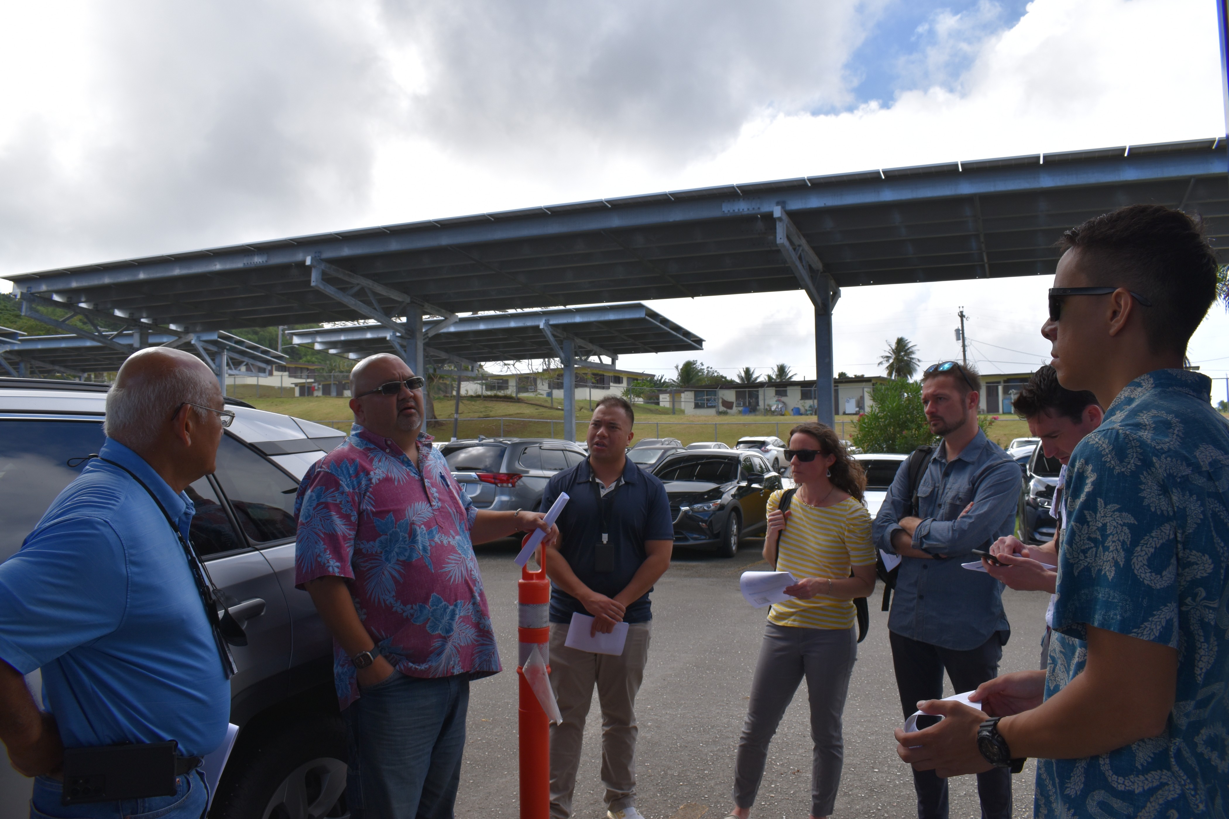 Commonwealth Healthcare Corporation‘s Warren Villagomez, second left, walks representatives from the Commonwealth Utilities Corporation, Pacific Northwest National Laboratory, U.S. Department of Energy, and the Office of Planning and Development through the specifications and alternative energy capabilities of CHCC’s Solar Photovoltaic Parking Structure. Constructed in 2019, the system produces 180 kilowatts of power for the hospital and was engineered to withstand more than 200 mile-per-hour wind speeds. 