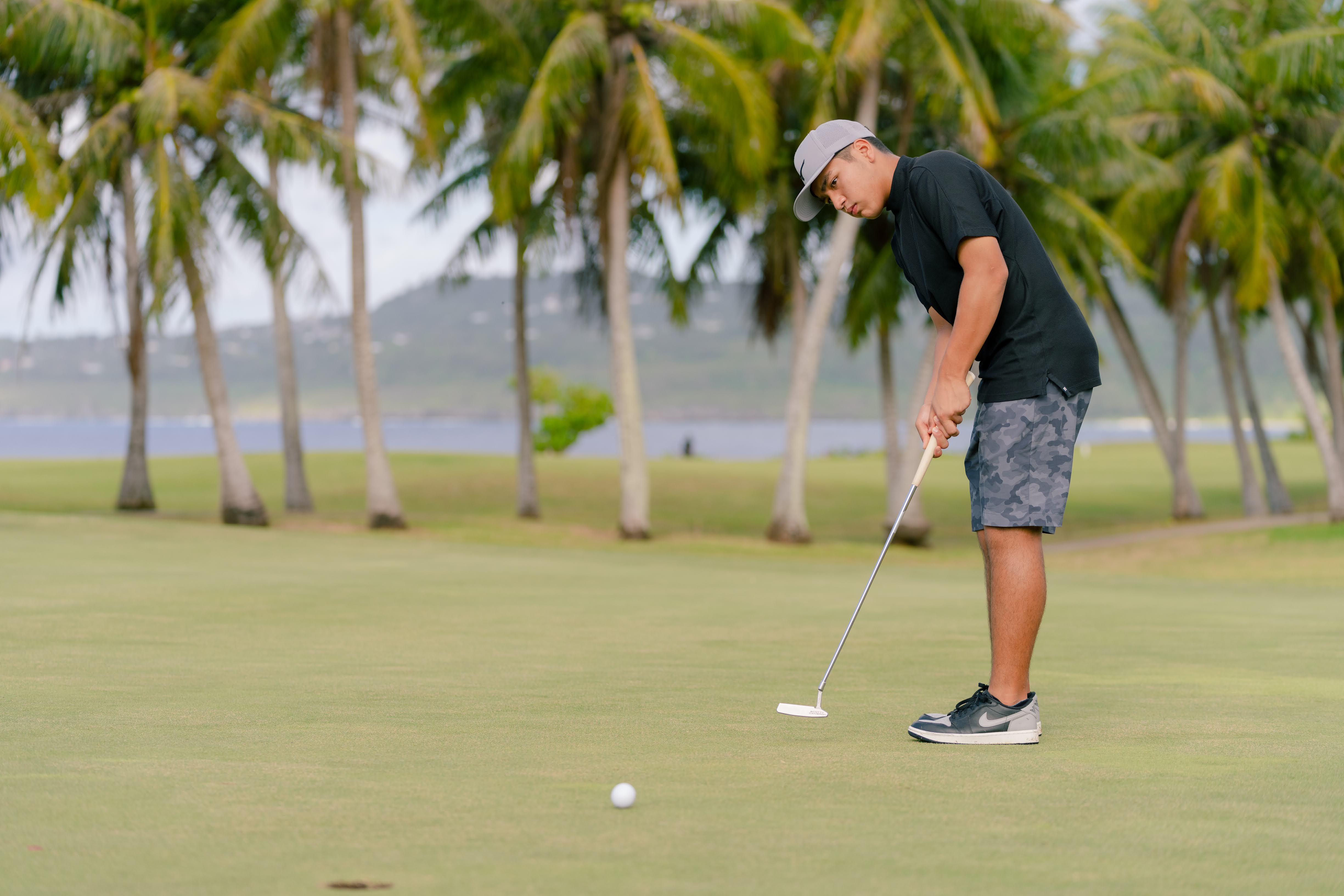 Guam junior golfer Stüssy Shiroma sinks a putt during the NMC Foundation’s Golf Open in March 2022.