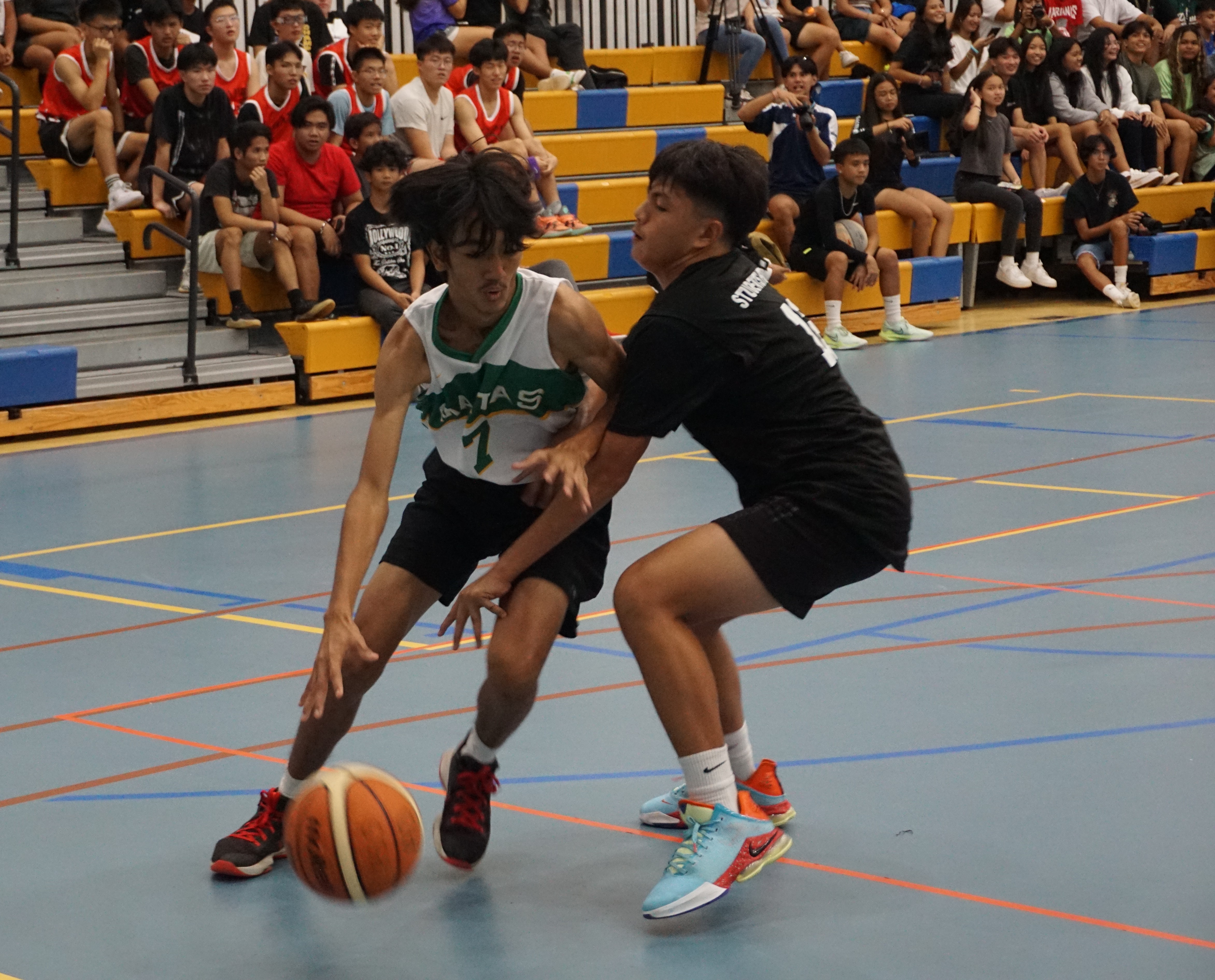 SSHS JVs' Simon Tang protects the ball as he posts up against a defender during a boys high school division game of the IT&E Interscholastic Basketball League at the MHS gym.