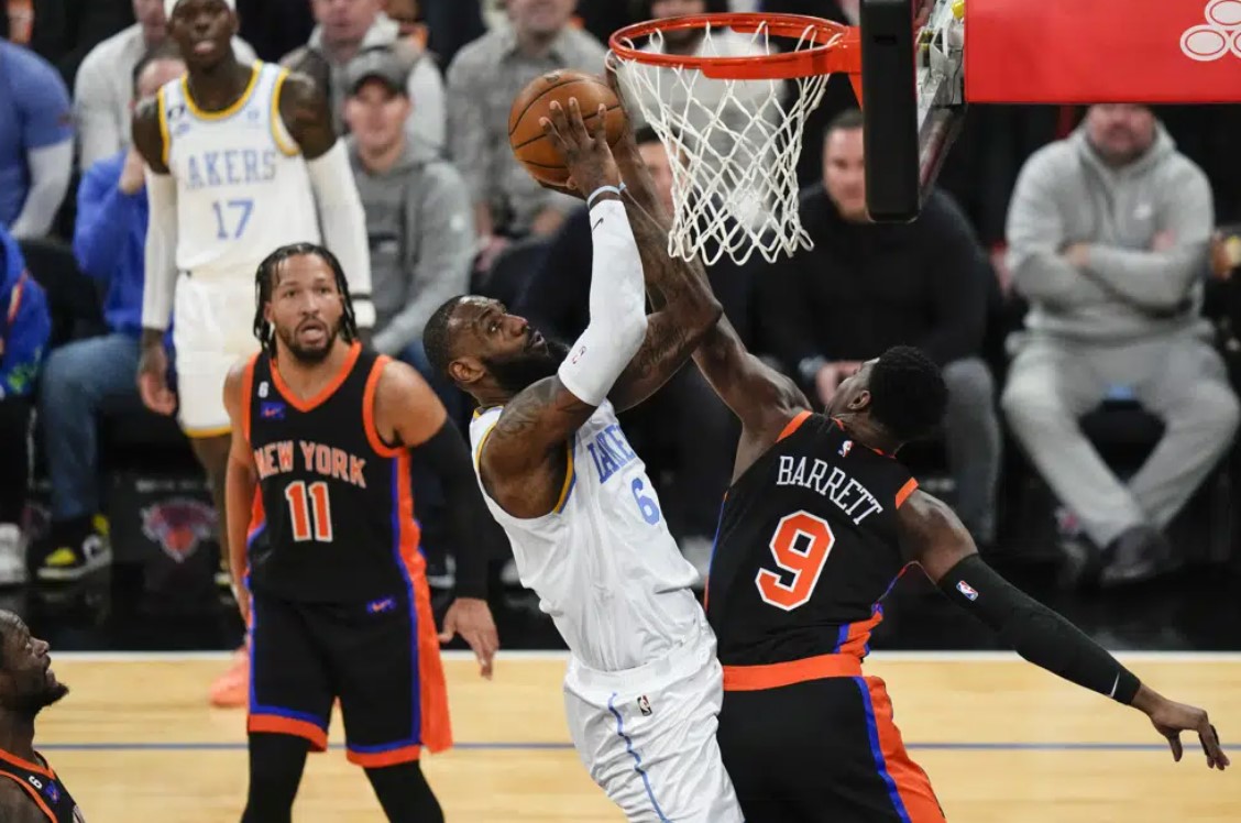 Los Angeles Lakers' LeBron James (6) shoots over New York Knicks' RJ Barrett (9) as Jalen Brunson (11) watches during the first half of an NBA basketball game Tuesday, Jan. 31, 2023, in New York.