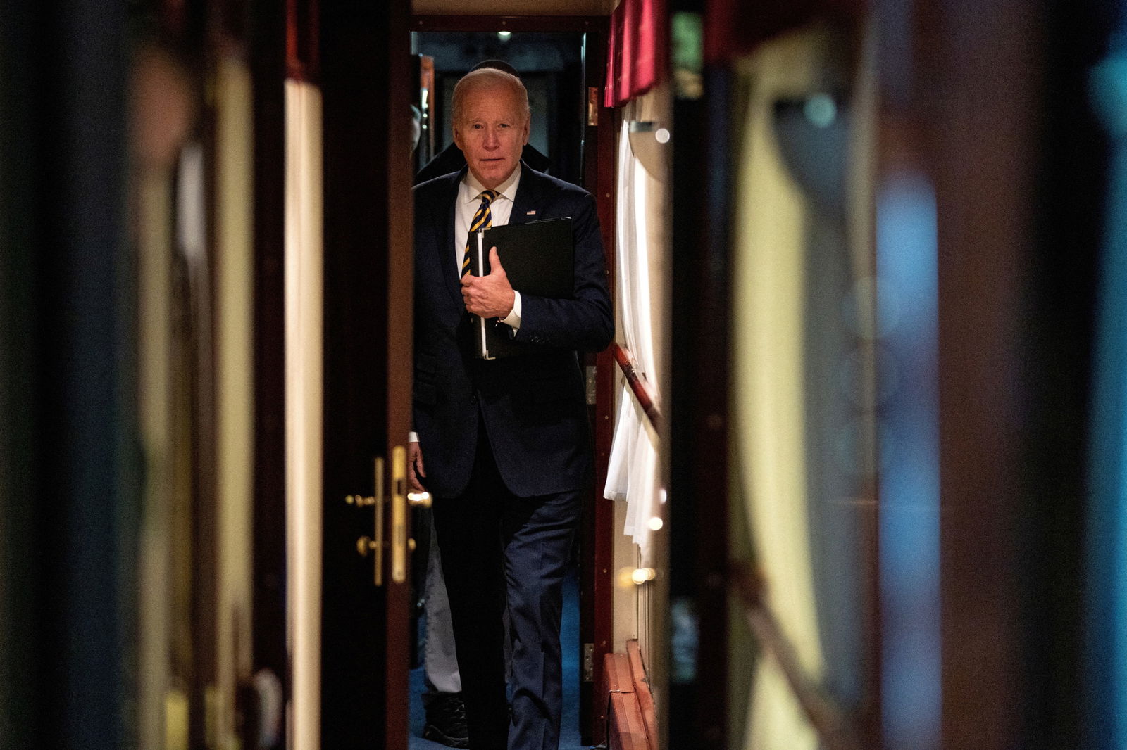 President Joe Biden walks down a corridor to his cabin on a train after a surprise visit with Ukrainian President Volodymyr Zelenskiy, Monday, Feb. 20, 2023, in Kyiv. Biden took a nearly 10-hour train ride from Poland into Kyiv.