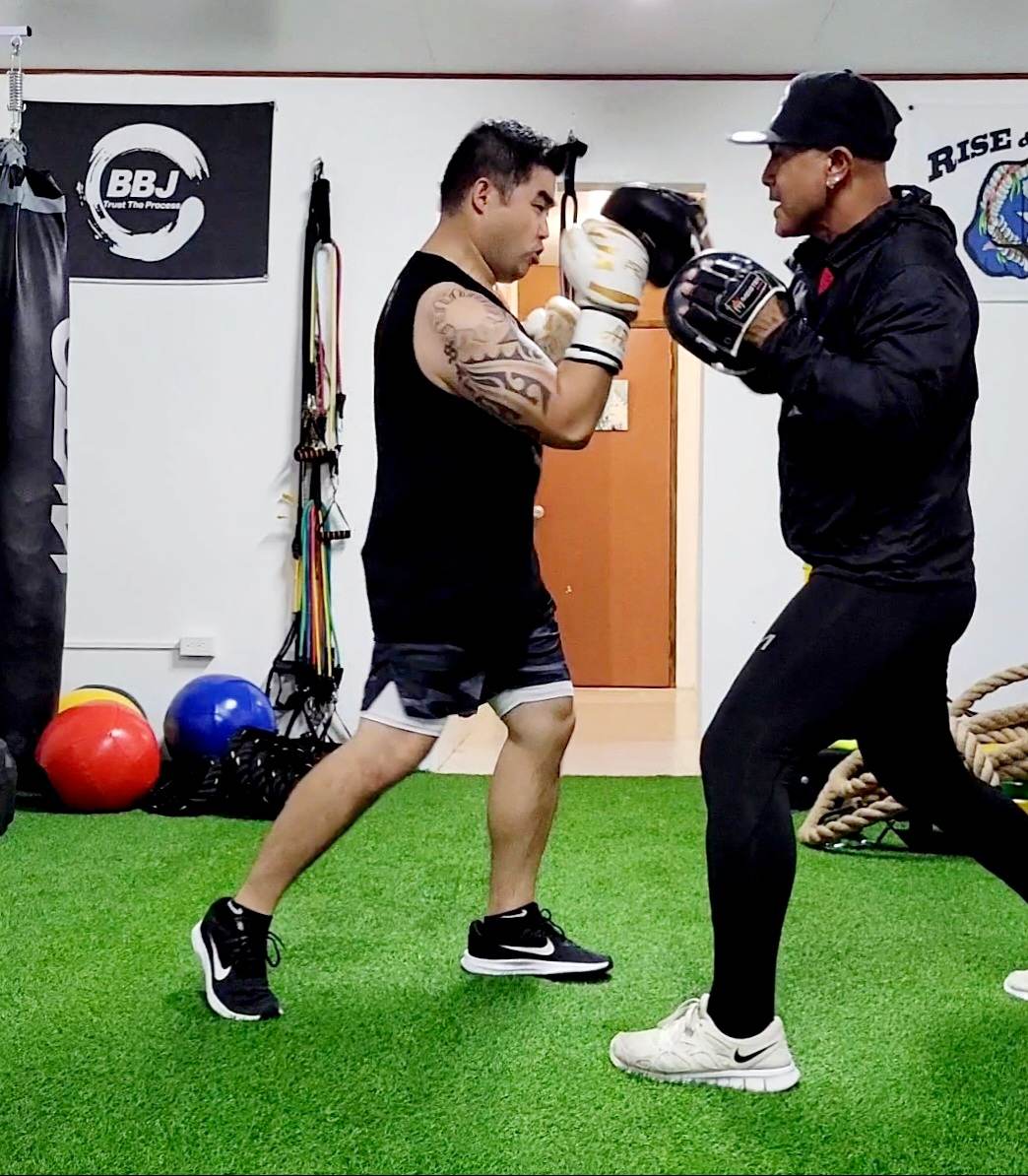 Carldrine Santos, left, undergoes boxing fitness training with Jerry Diaz at BBJ Athletics Studio.