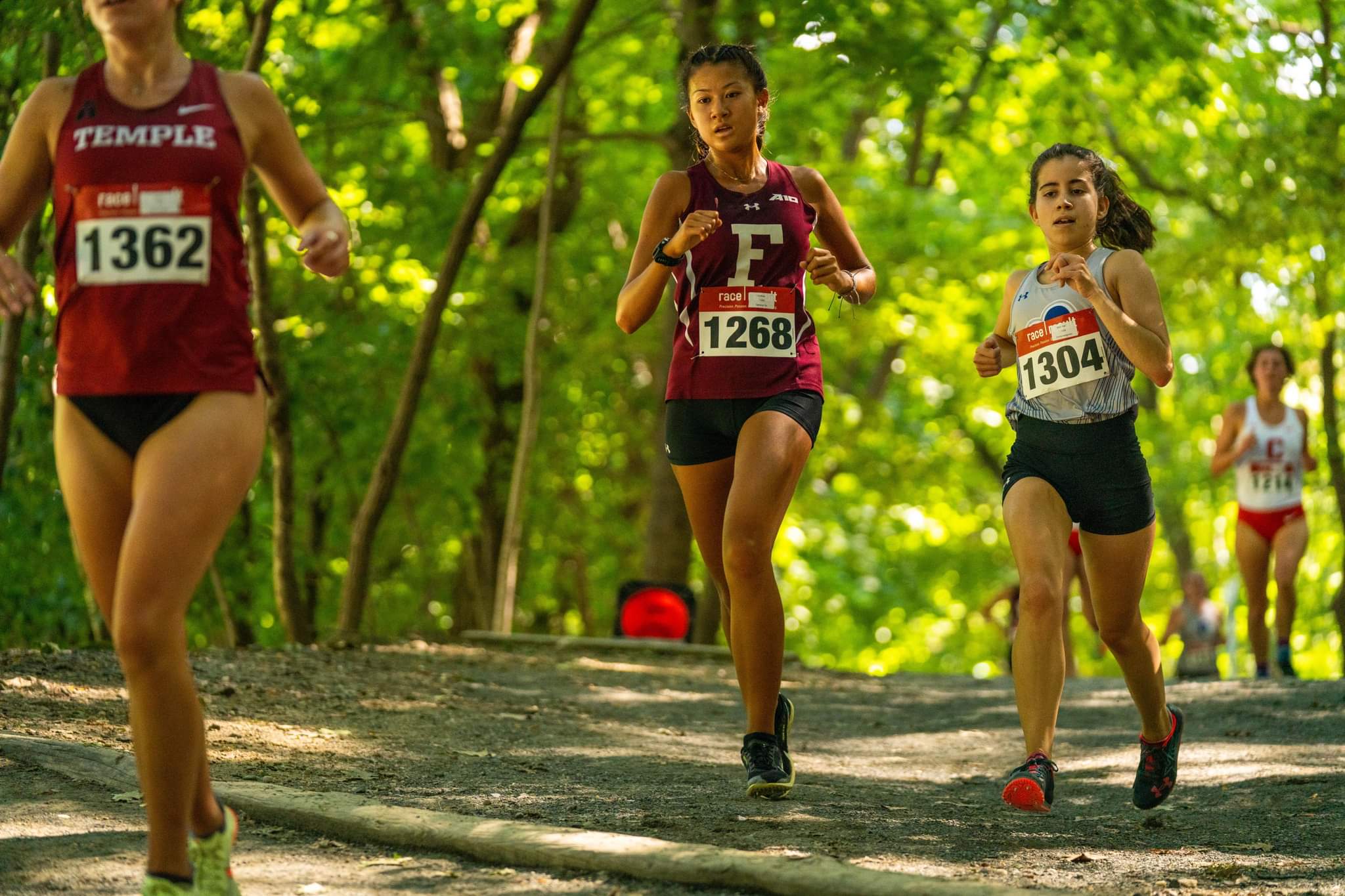 Tania Tan, center, makes her way through the outdoor course of the Fordham Fiasco Cross Country Meet on Sept. 10, 2022. 