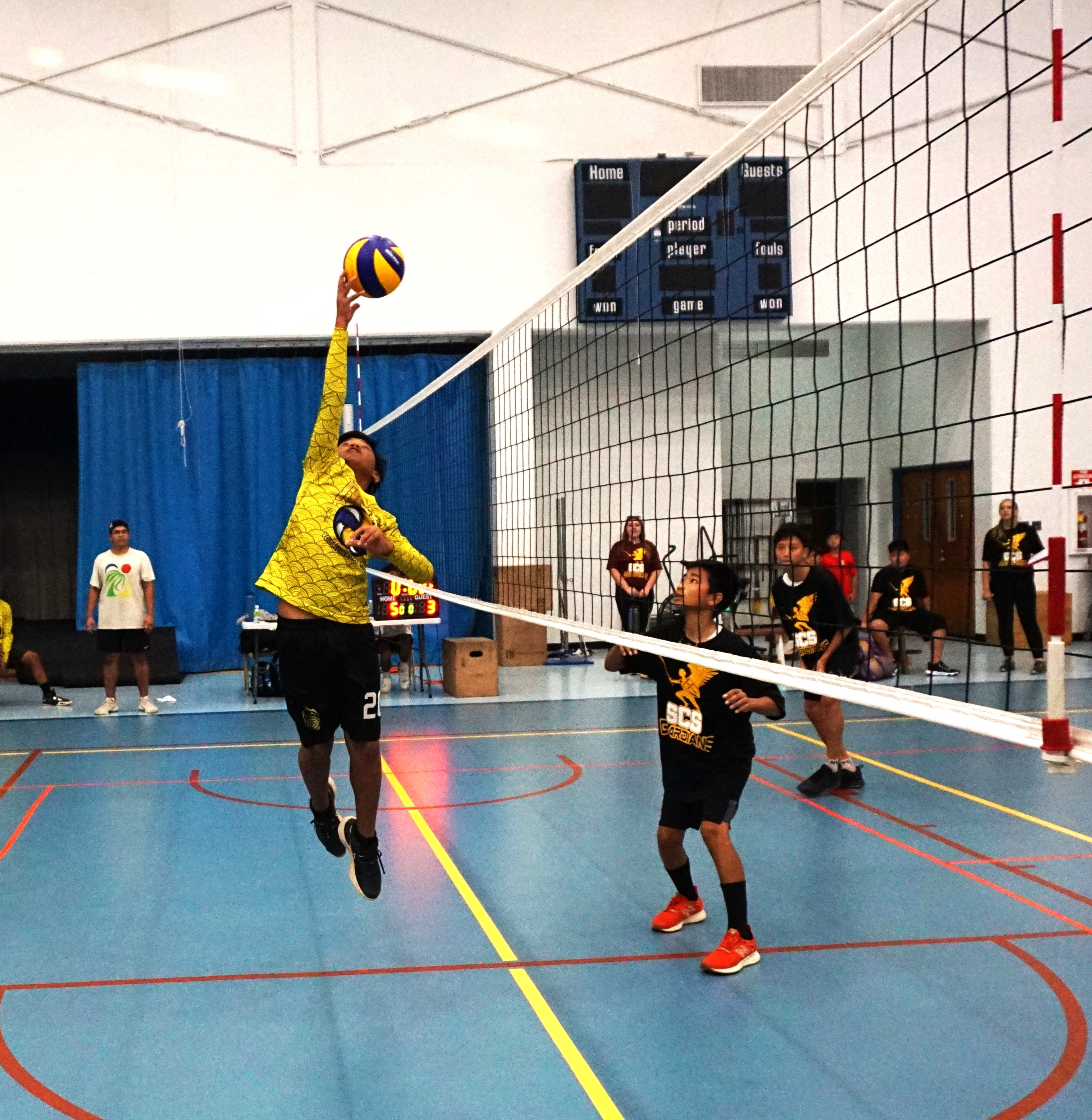 Dandan Middle School JV's Kianu Camacho tips the ball over for a point during a boys middle school division game of the NMIVA-PSS Interscholastic Volleyball League on Tuesday at the MHS gym.