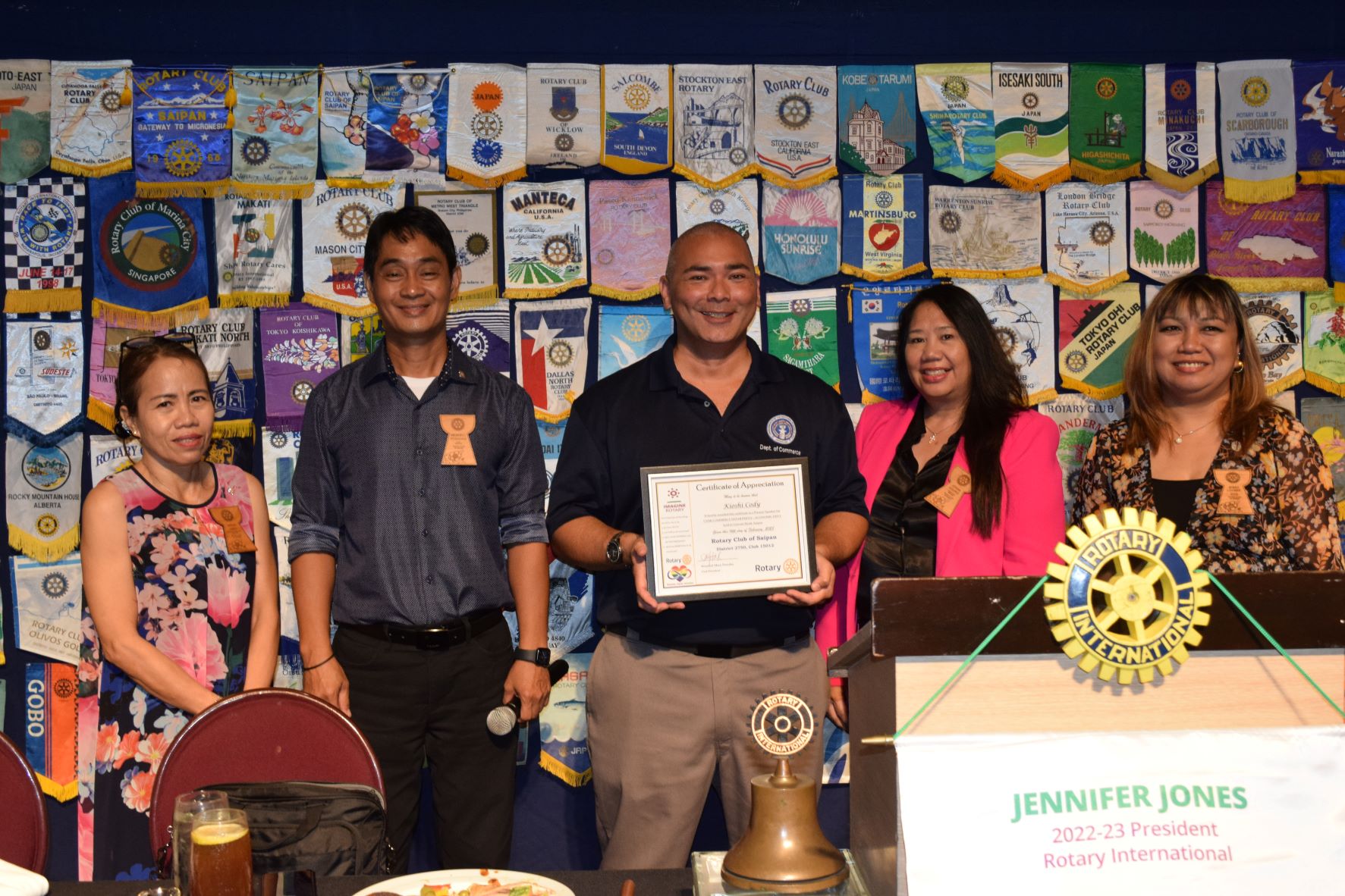 Department of Commerce economic development officer Kioshi Cody, center, poses for a photo with Rotary Club of Saipan President Wendell Posadas, second left, President-elect Irene Holl, left, Secretary Joann Aquino, second right, and Vice President Jessy Loomis, right, during the club's weekly luncheon meeting at the Hyatt Regency Saipan Ballroom on Tuesday.