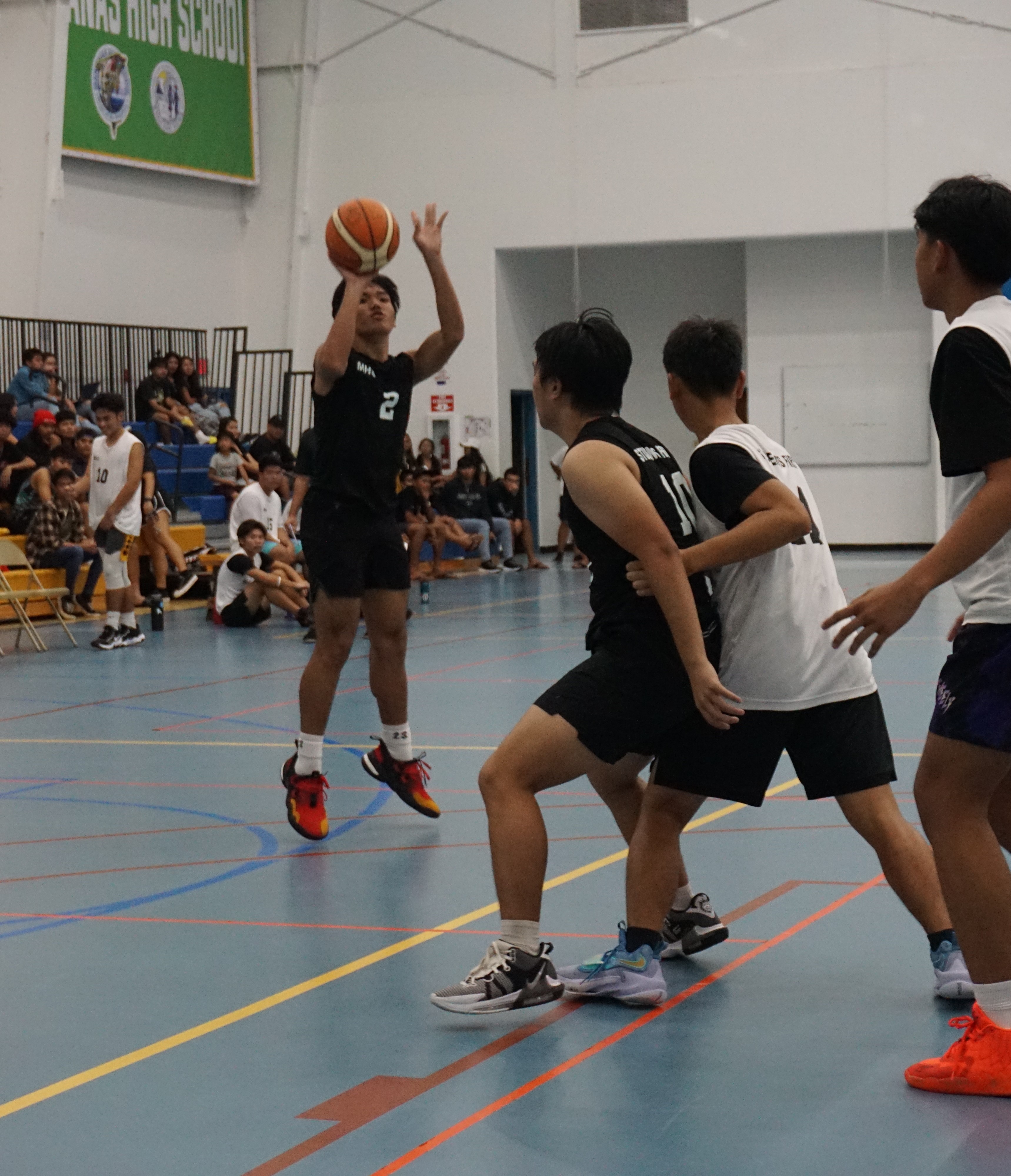 MHS JV 2's Webb Alano Jr. takes the three-point shot after being freed from a teammate's screen during a high school division game of the IT&E Interscholastic Basketball League on Wednesday at the MHS gym.