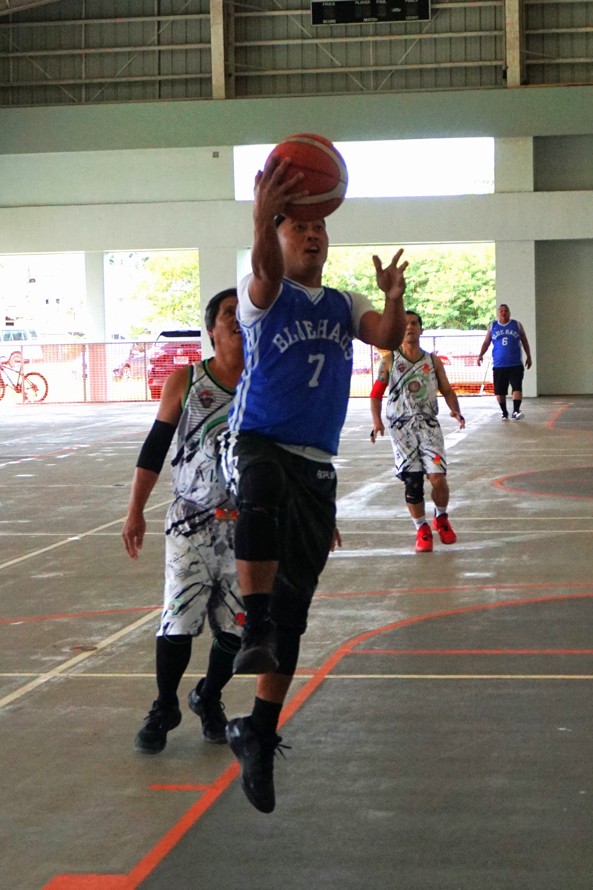 Blue Haus' Elmer Esdrelon extends for the layup finish during a Legends Sports Association Invitational Basketball League game at the Koblerville gym.