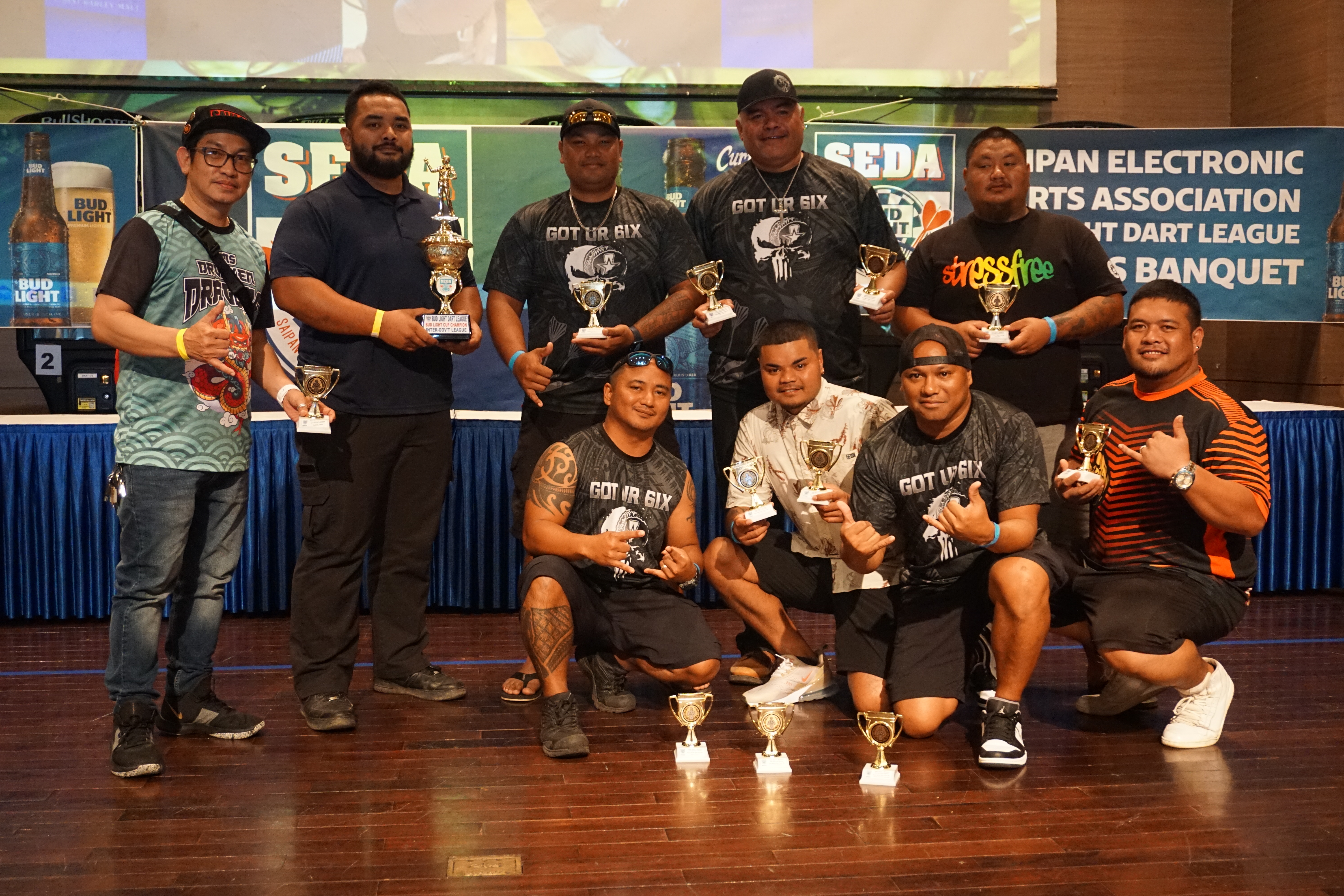 True North Got Your 6ix team members receive the Bud Light Cup title and other trophies for finishing first in the Inter-Government Division of the SEDA Bud Light Dart League.