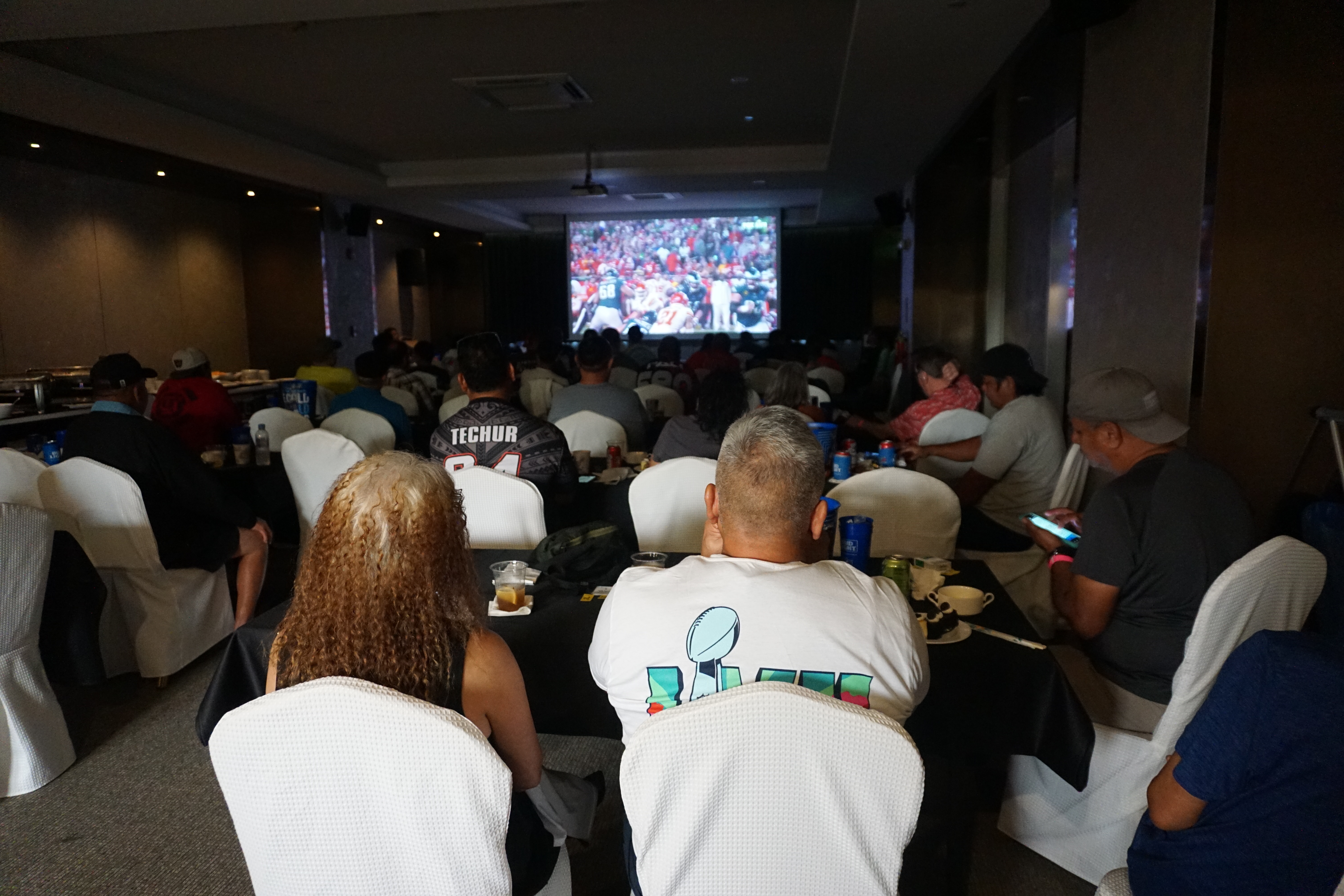 Local football fans fill the Sunflower Room of the Saipan World Resort as they root for their teams.