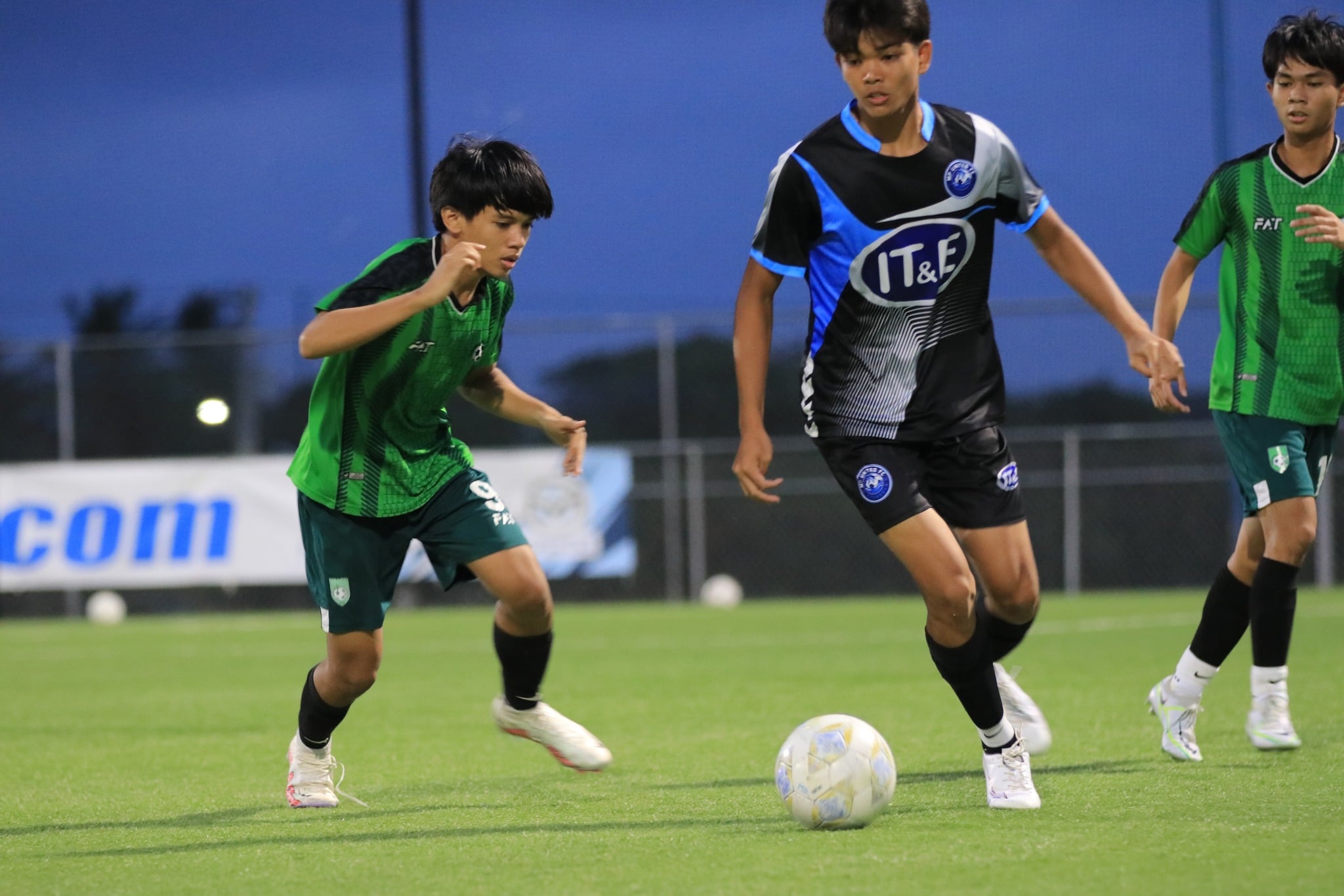 MP United's Cody Shimizu slips through Tan Holdings defenders during   a U17 boys division game of the TakeCare Youth Soccer League at the NMI Soccer Training Center on Saturday.