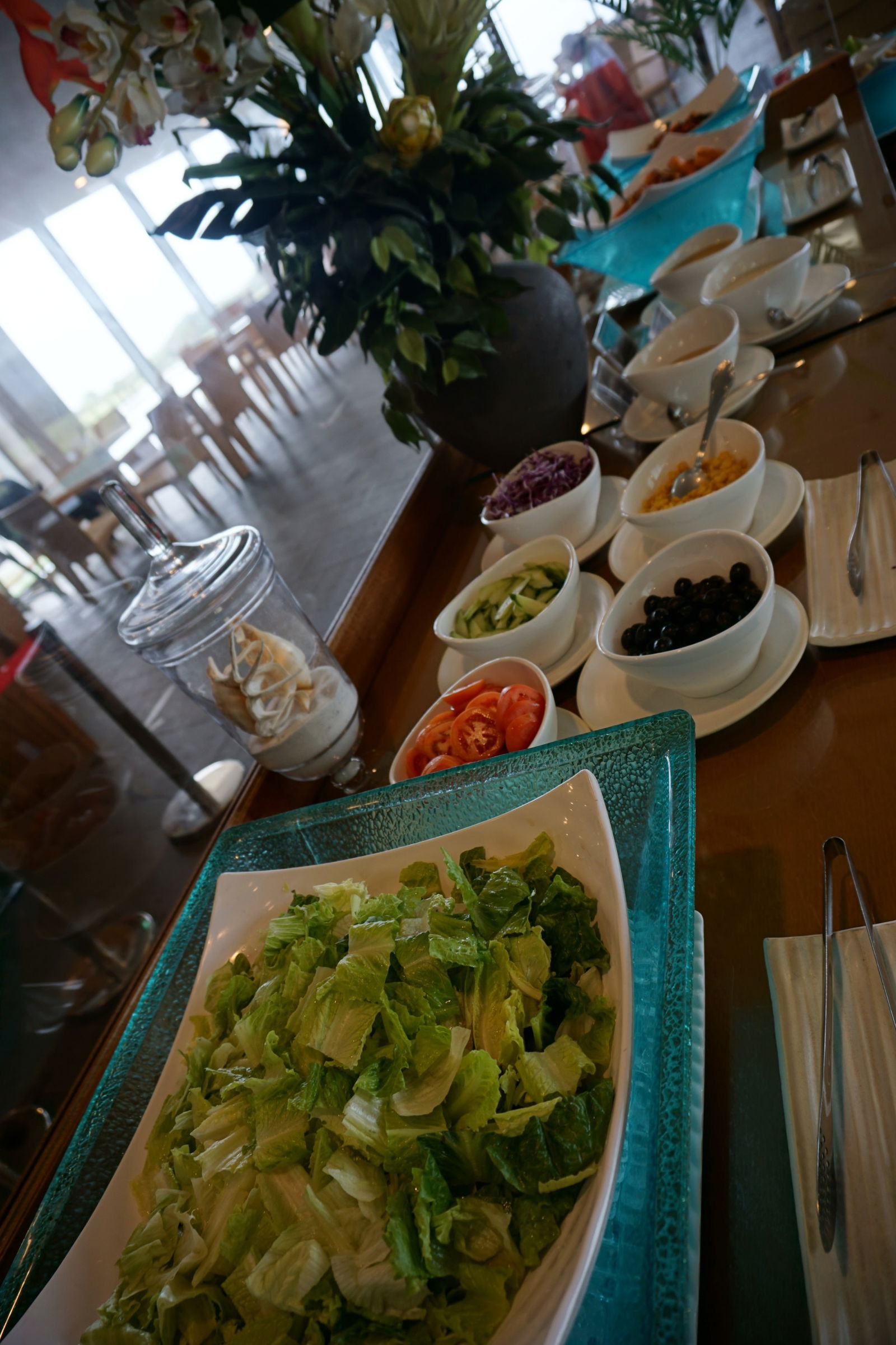 The salad table is filled with fresh greens.