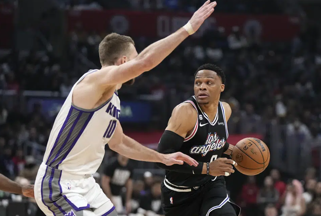 Los Angeles Clippers guard Russell Westbrook, right, drives by Sacramento Kings forward Domantas Sabonis during the first half of an NBA basketball game Friday, Feb. 24, 2023, in Los Angeles.