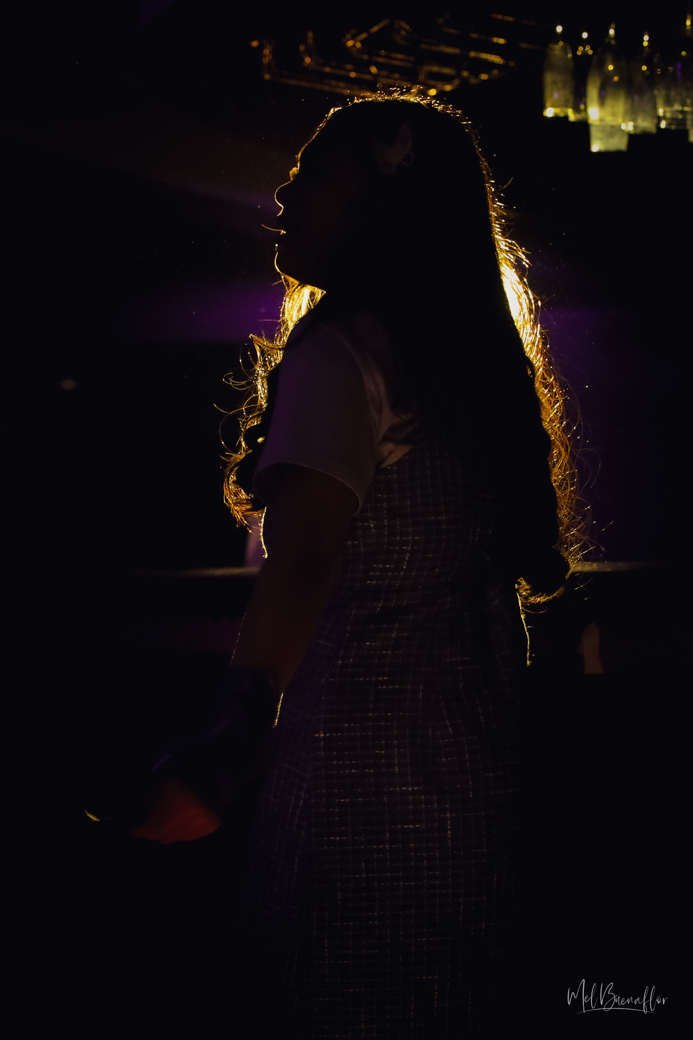 Iris, played by Bernice Shane Sabino, stands in a beautiful silhouette as part of the show’s light design for the signature performance of “This is Me.”